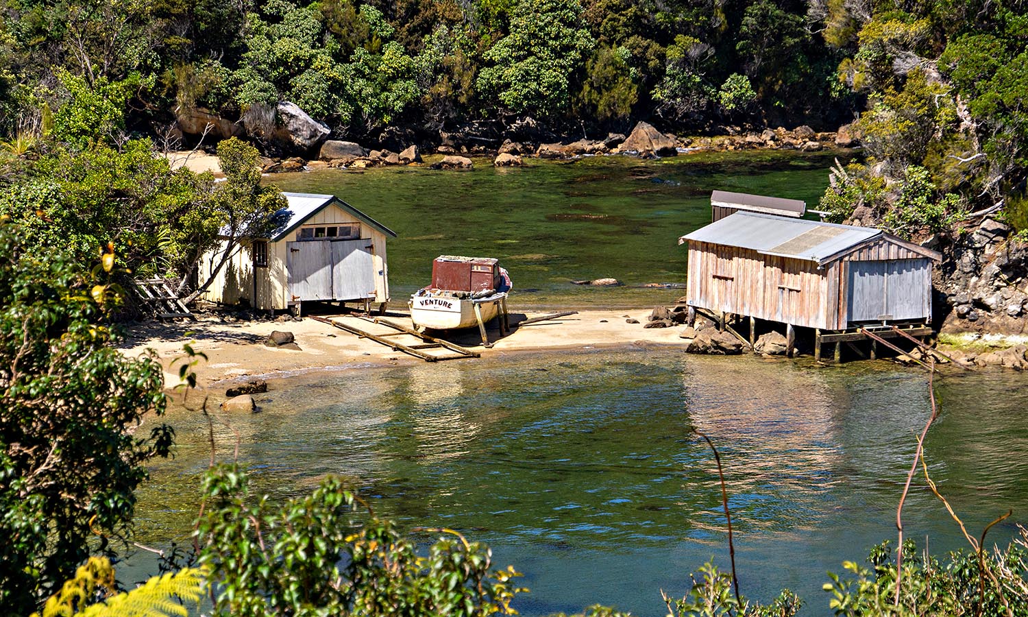 A couple of sheds on the water's edge of Stewart Island.