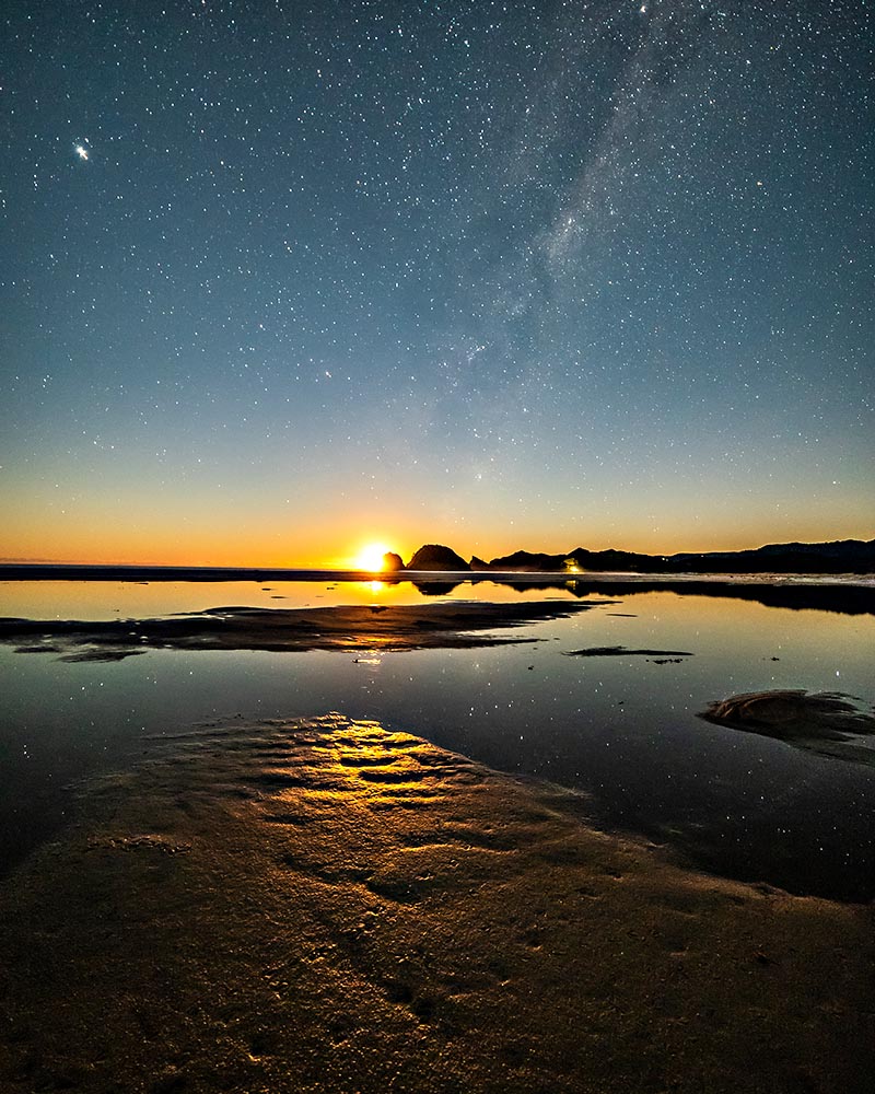 The inky black water of Great Barrier Island as the sun goes down and the stars come out.