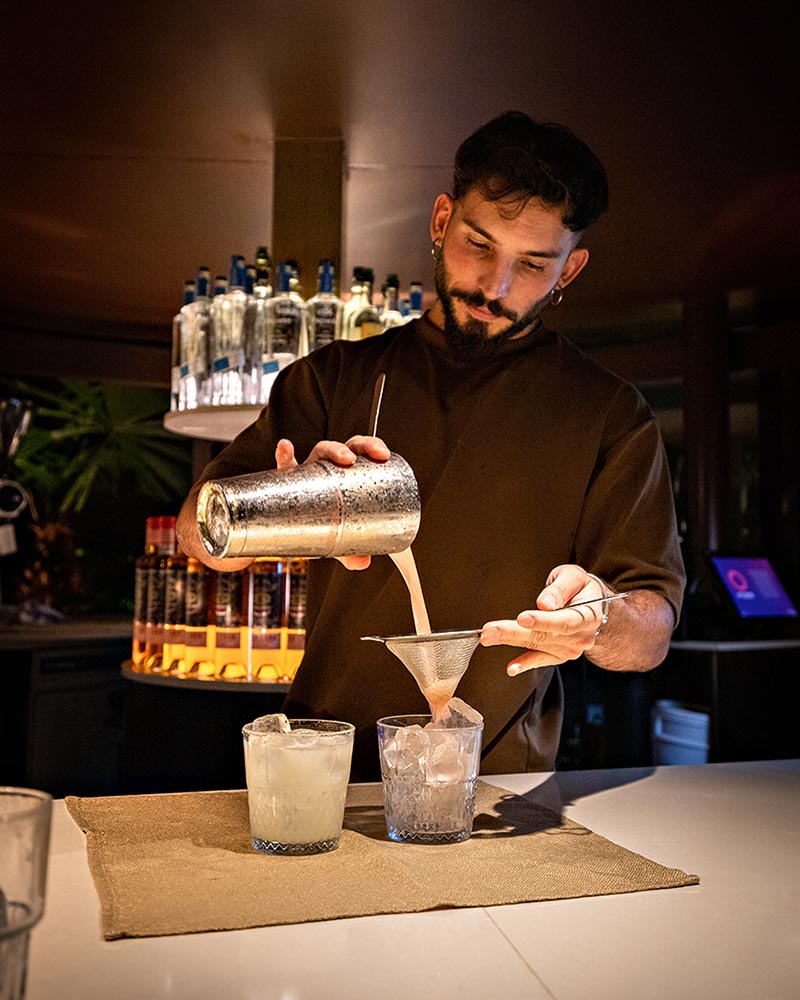 A man pours a cocktail behind the bar at Southside Restaurant in Brisbane.