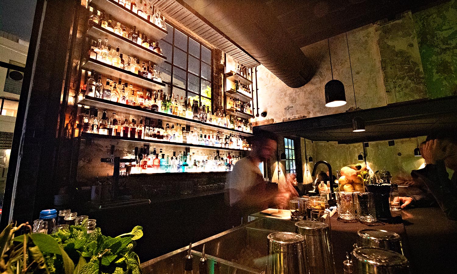 A man works behind the bar at Agnes Restaurant.
