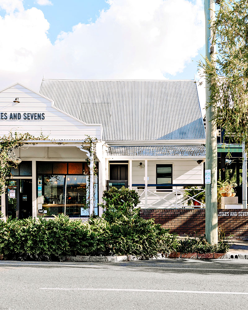 The white gabled exterior of Sixes and Sevens in Brisbane.