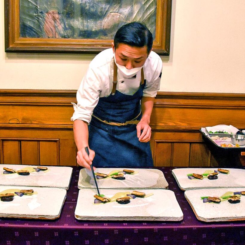 A Japanese chef plates up some traditional food.