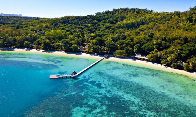 The main beach and pier of Turtle Island, surrounded by clear turquoise water.