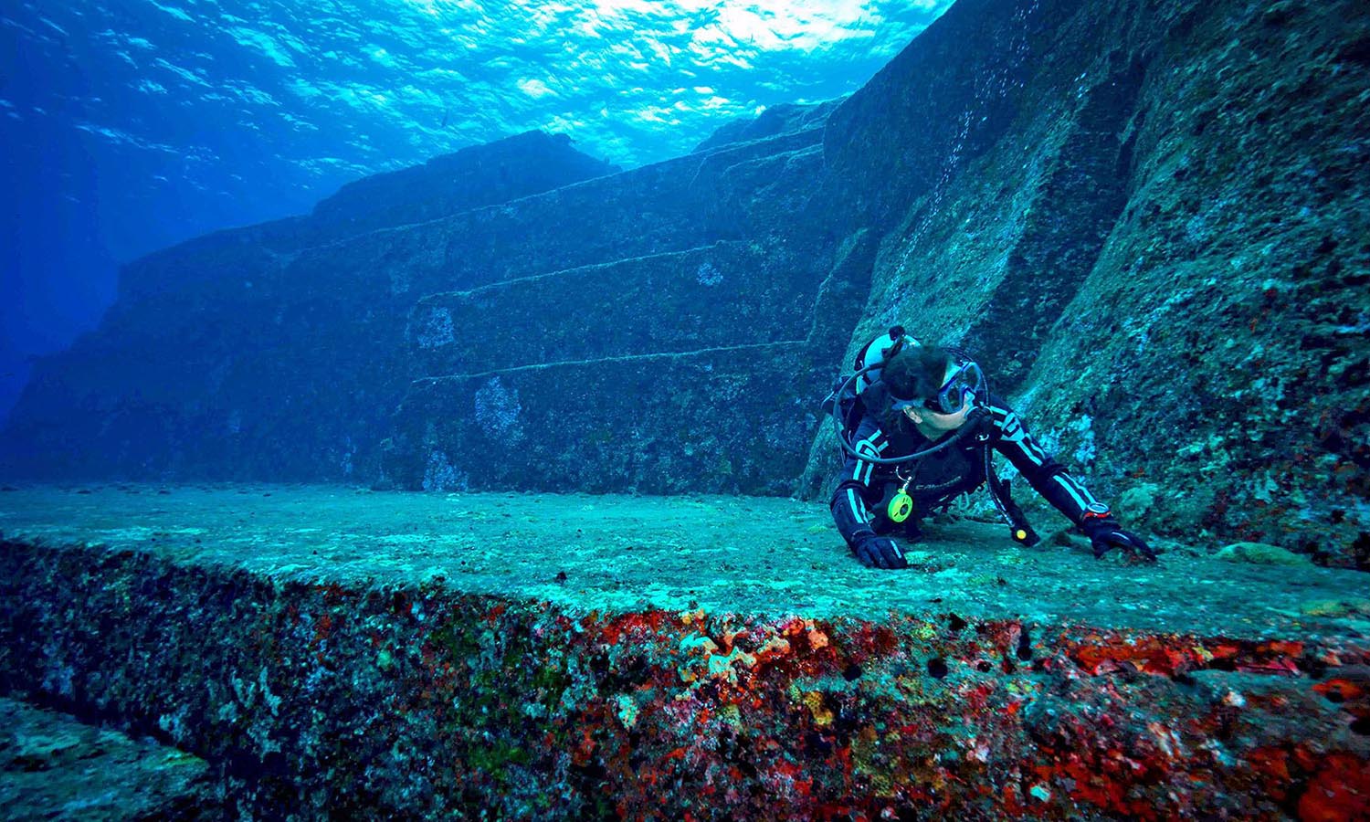 A diver exploring the Yonaguni Monument underwater.