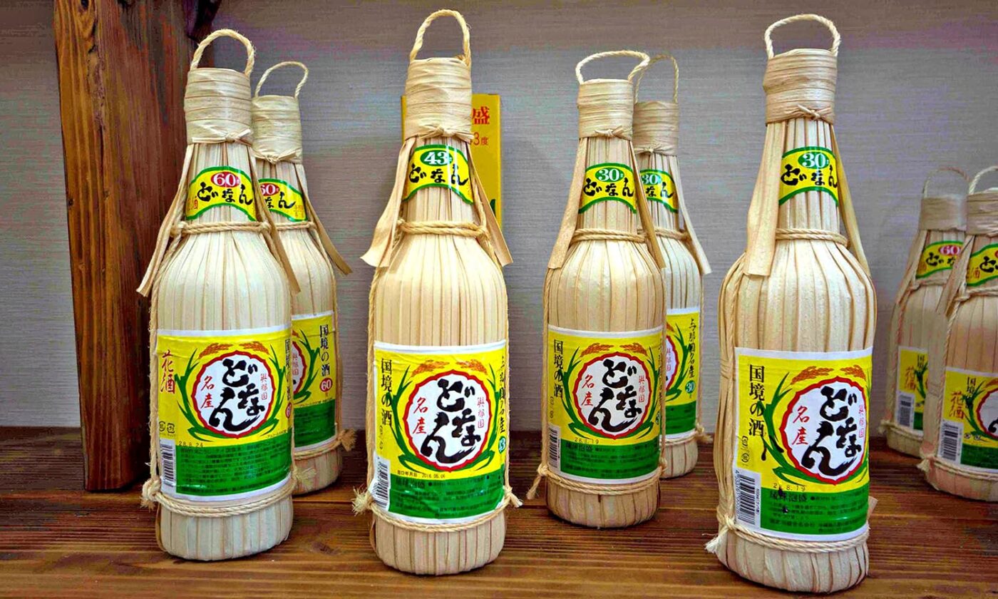 A group of bottles of Hanasake stand on a shelf.