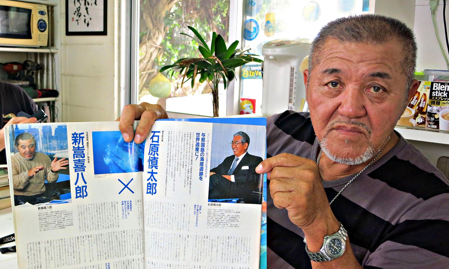 Kihachiro Aratake proudly showing his magazine article.