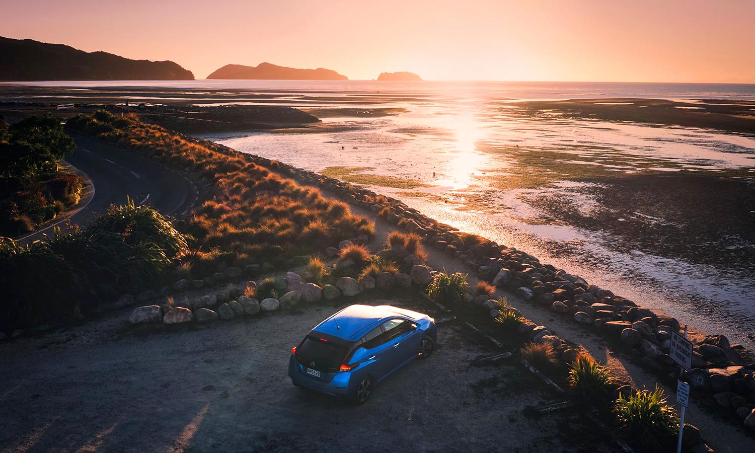 Our Nissan Leaf parked up to watch the sunrise at Mārahau.