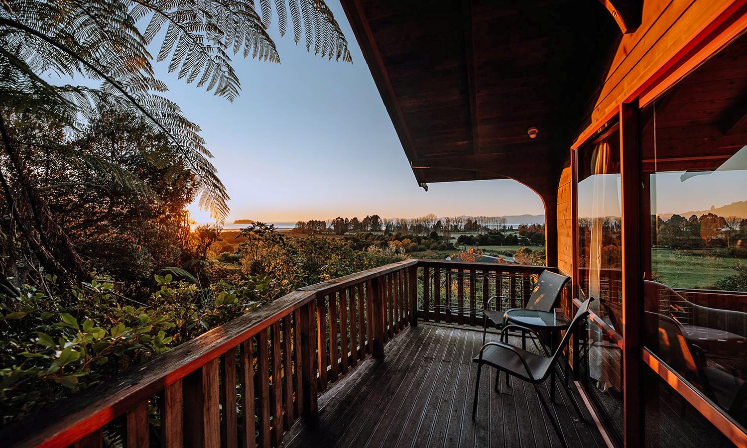 Sunrise on the balcony at Abel Tasman Ocean View Chalets.