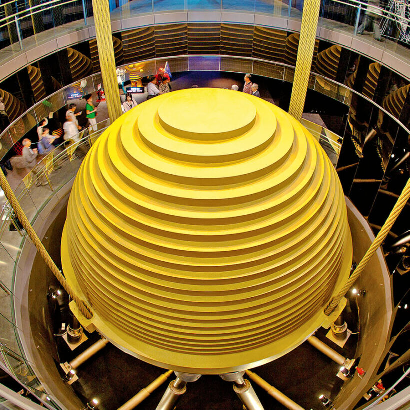 People crowd around a wind damper inside Taipei 101 tower.