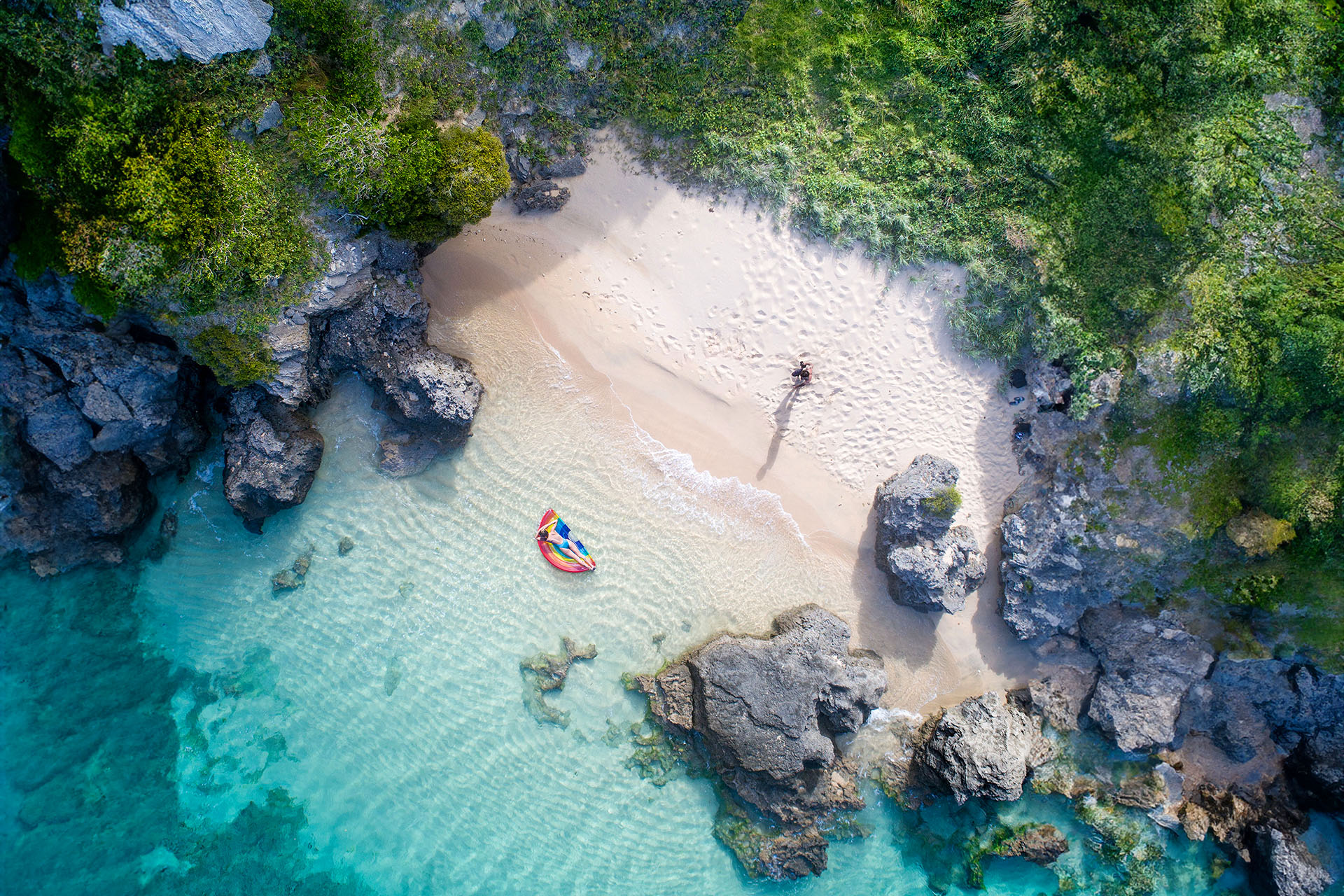 A couple of people enjoying the solitude of beach on Lord Howe Island.