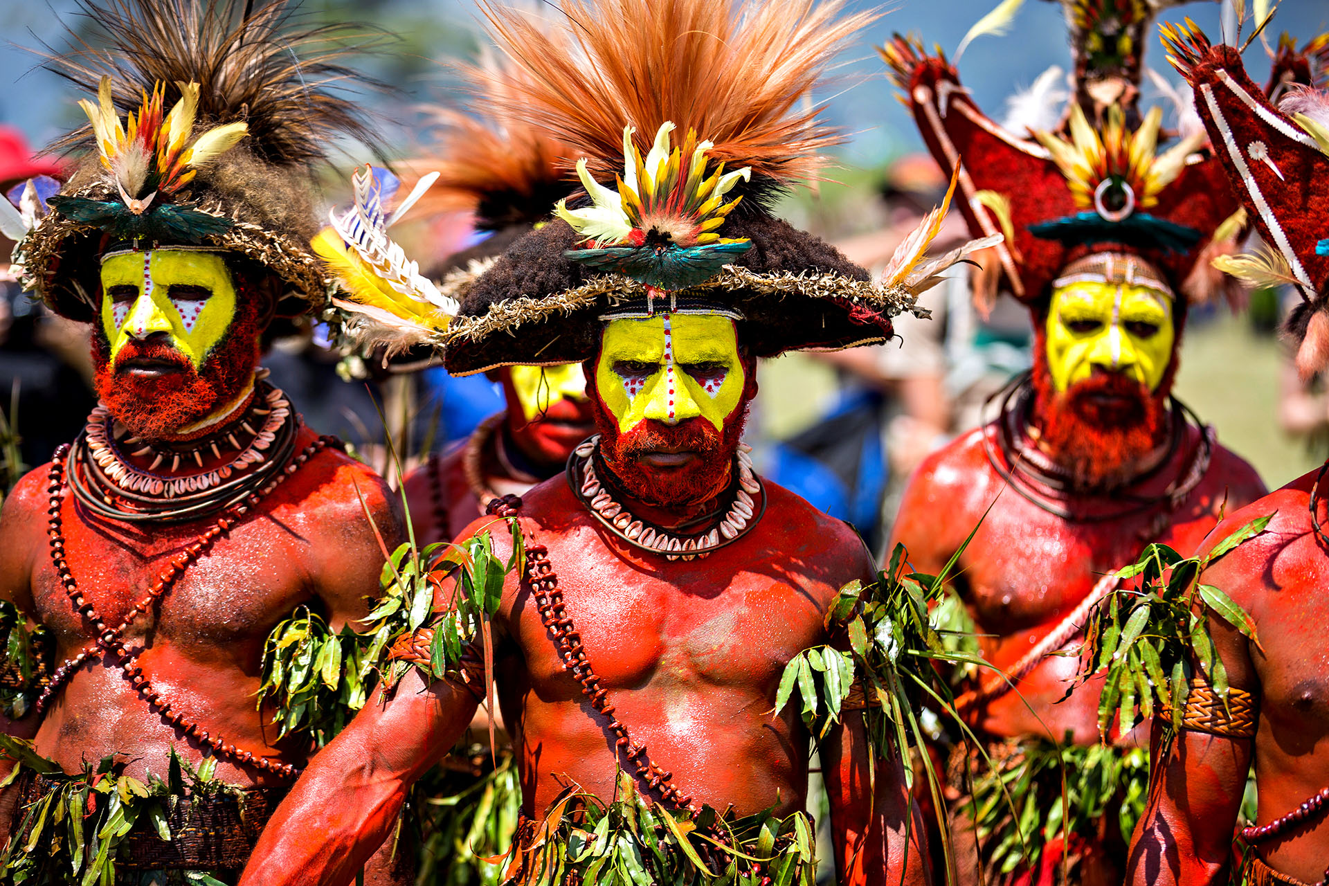 A group of men wearing traditional dress and makeup in Papua New Guinea.
