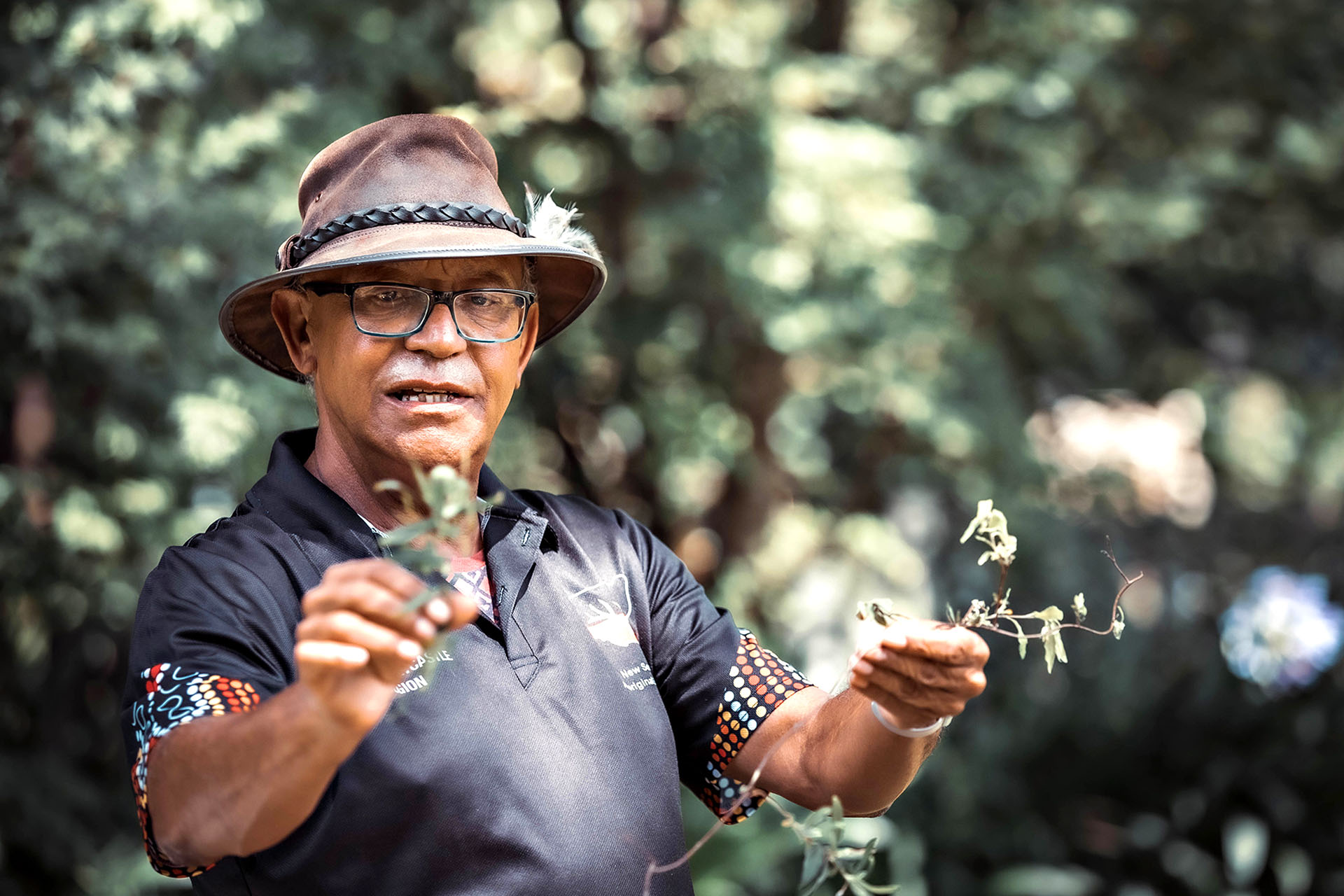 A local Aboriginal man holding eucalyptus.