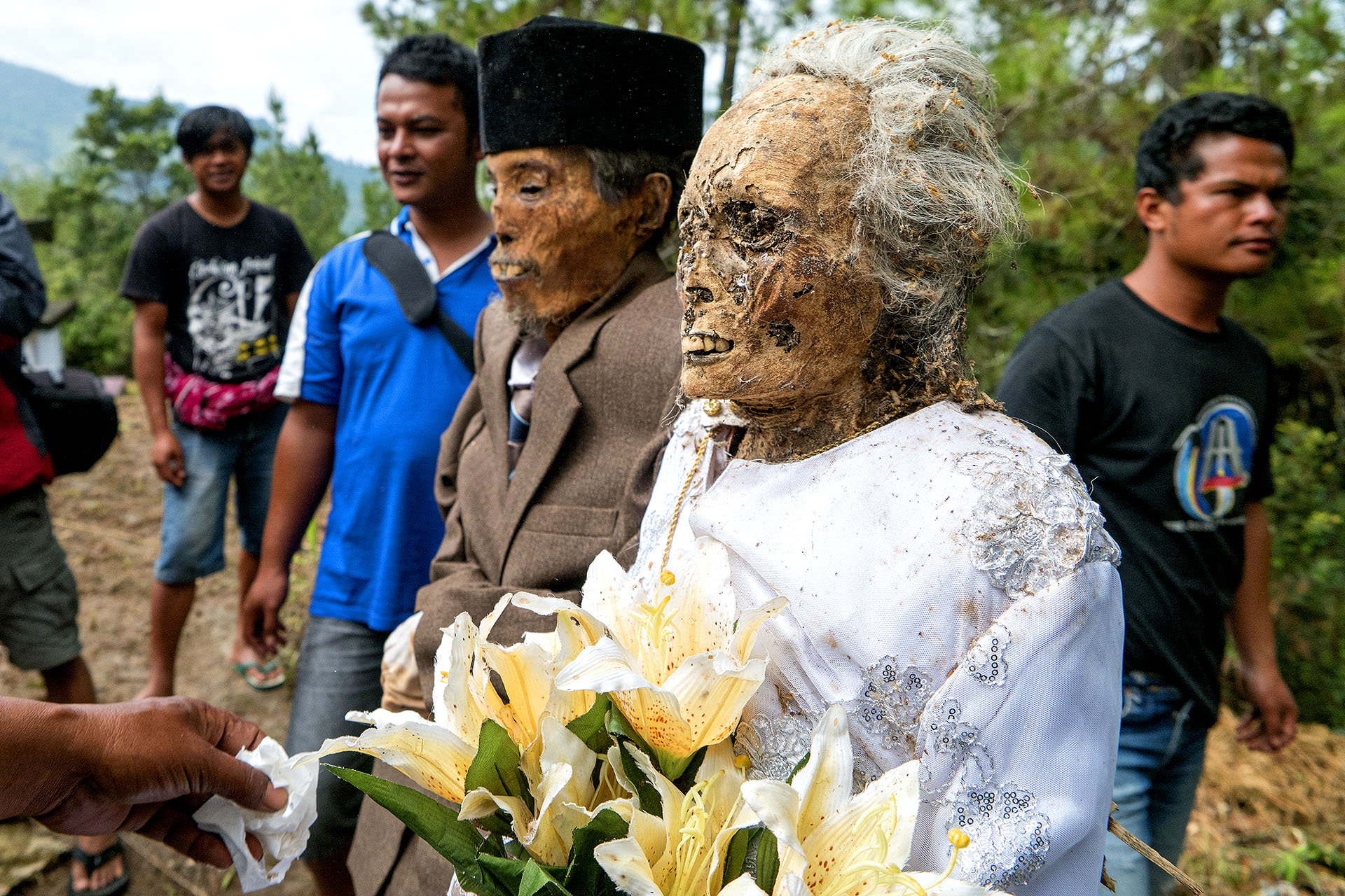 A couple of mummified corpses during a funeral ceremony in Indonesia.