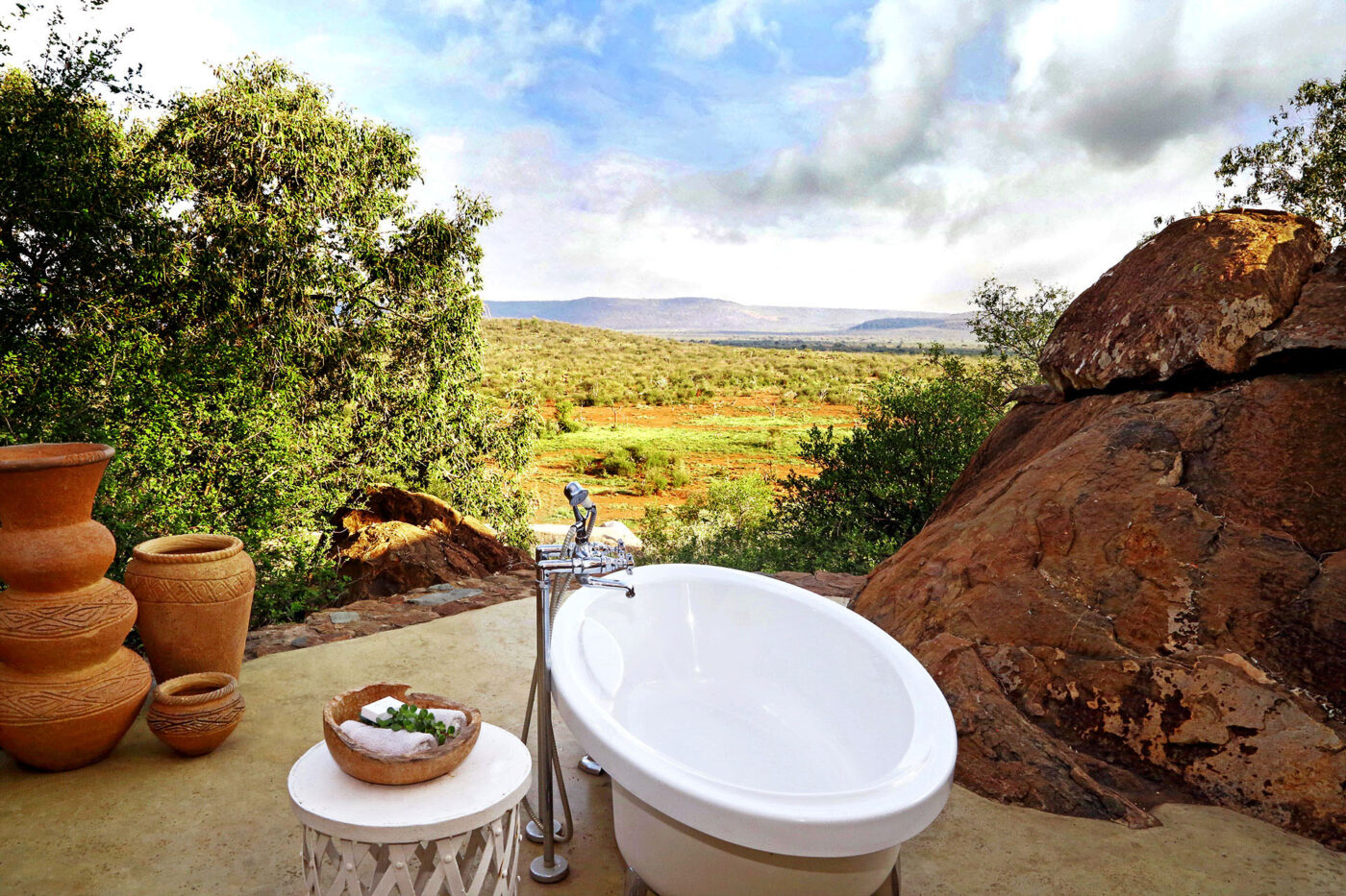 A bathtub sits at the edge of a precipe overlooking Madik We Game Reserve in South Africa.