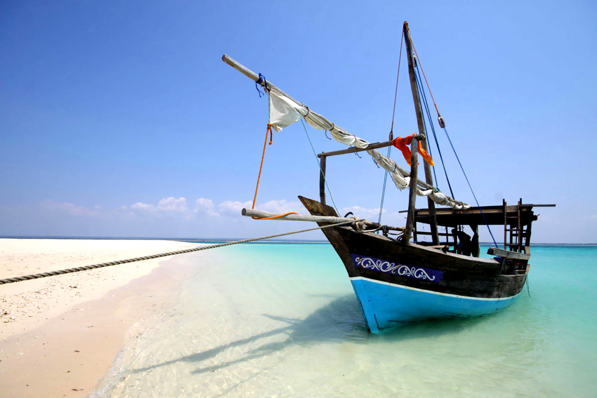 A boat is moored beside a stretch of pristine beach in Mozambique.