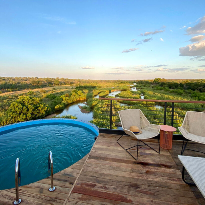 A swimming pool and lounge area on the deck at Kruger Shalati.