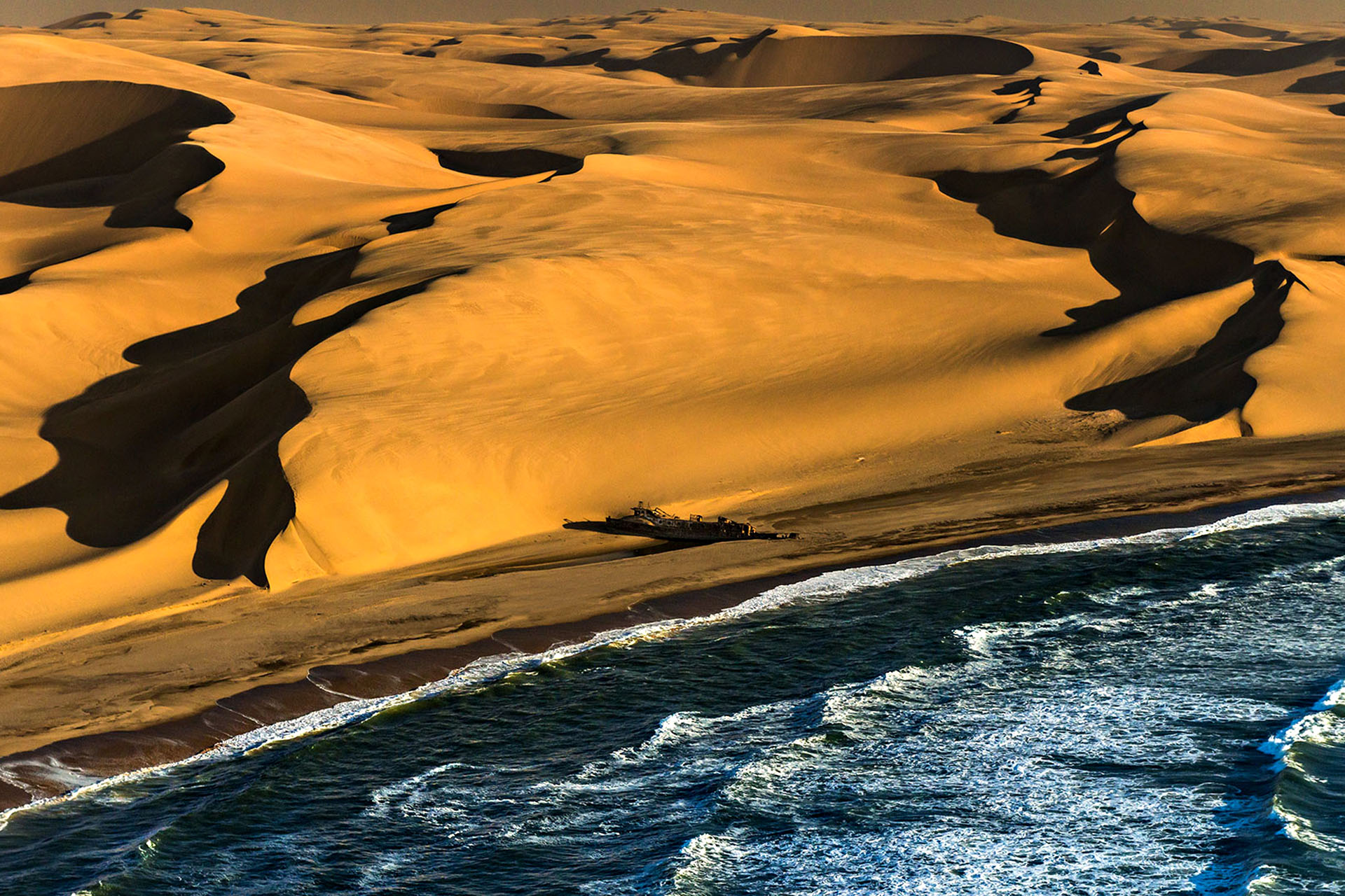 The sandy and ocean-y coastline of the Skeleton Coast in Namibia.