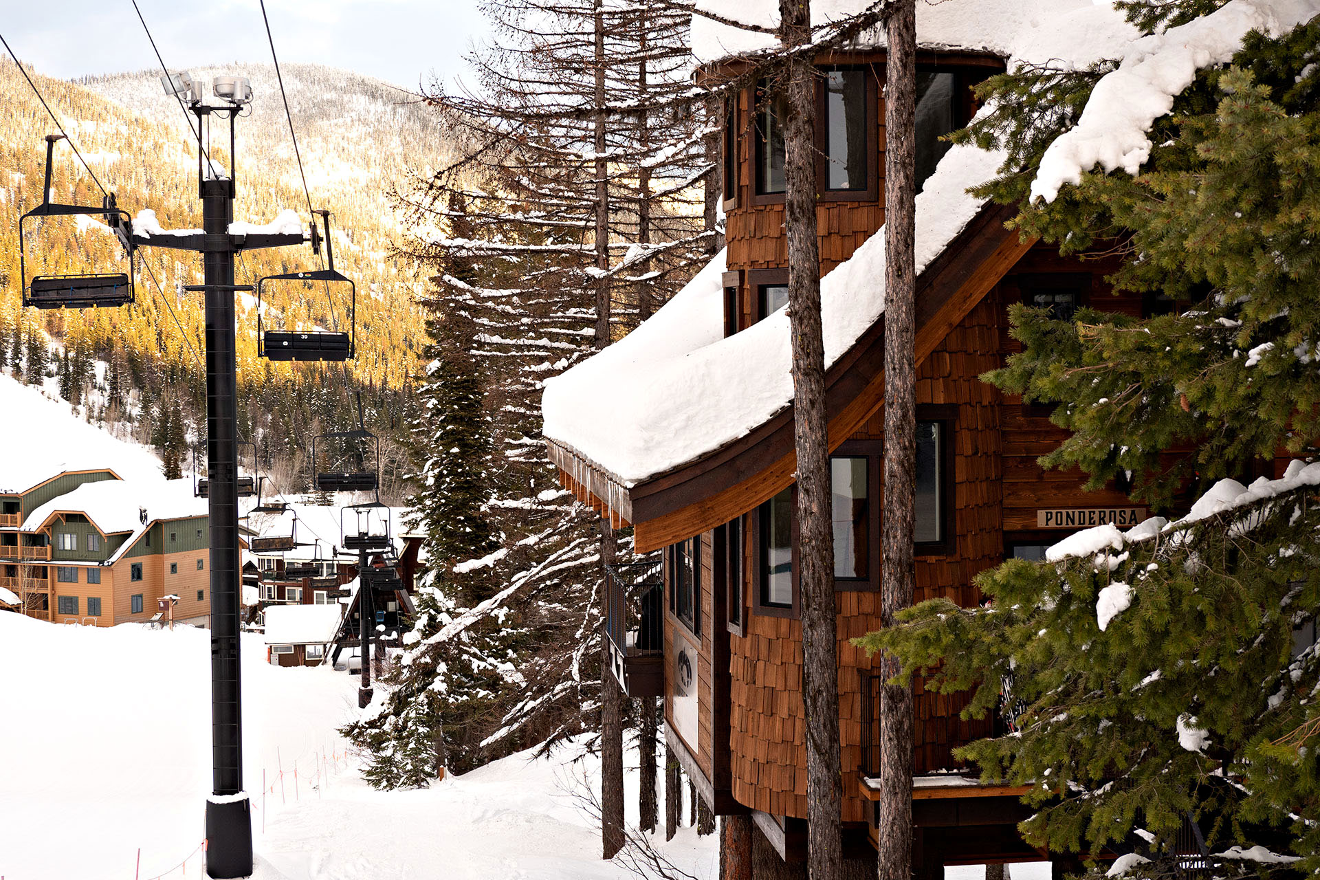 The snow-covered rooftop of Ponderosa Treehouse in Whitefish Mountain, Montana.