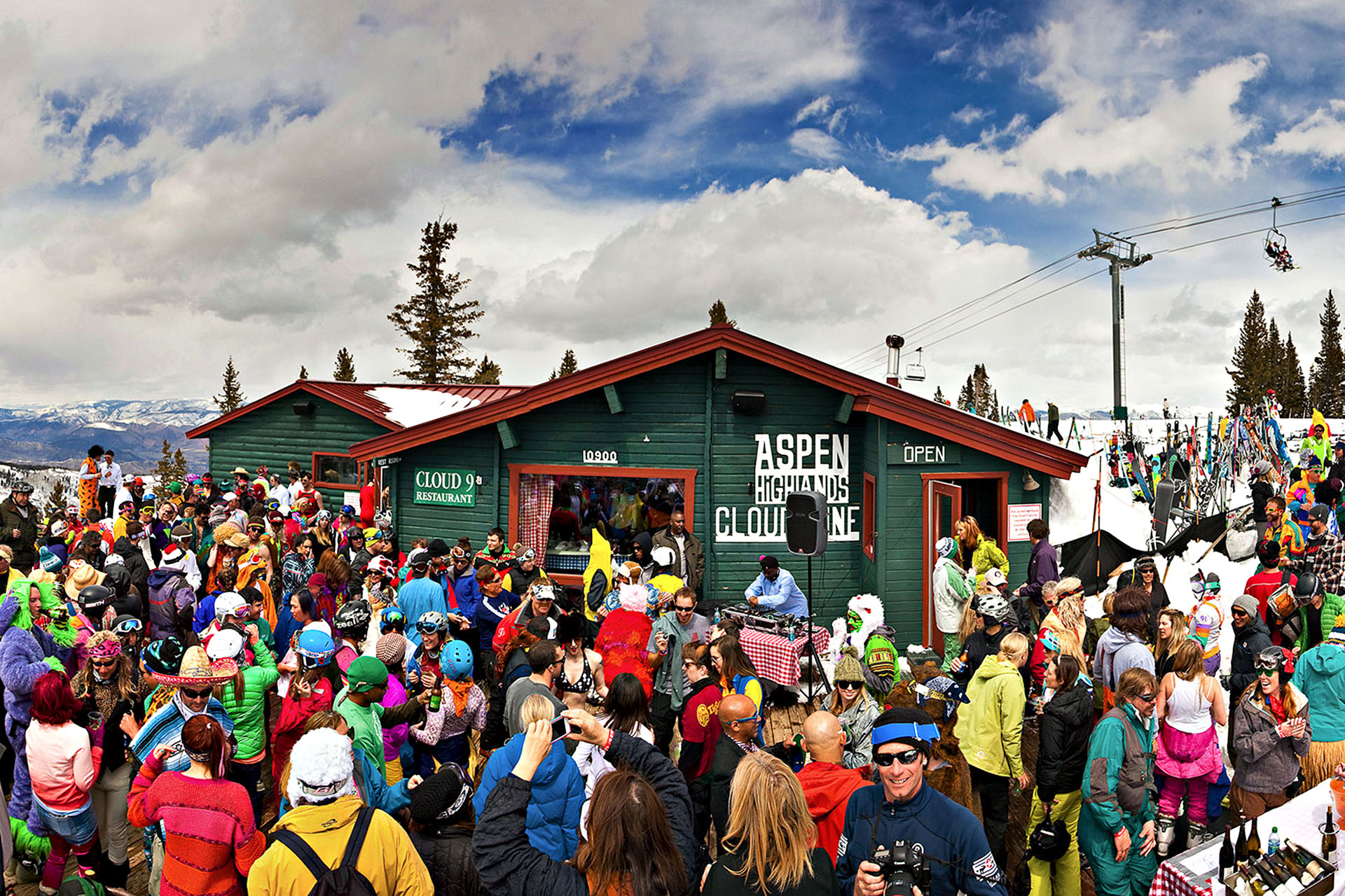 A large crowd gathers around a DJ as he pumps tunes into the open in Aspen.