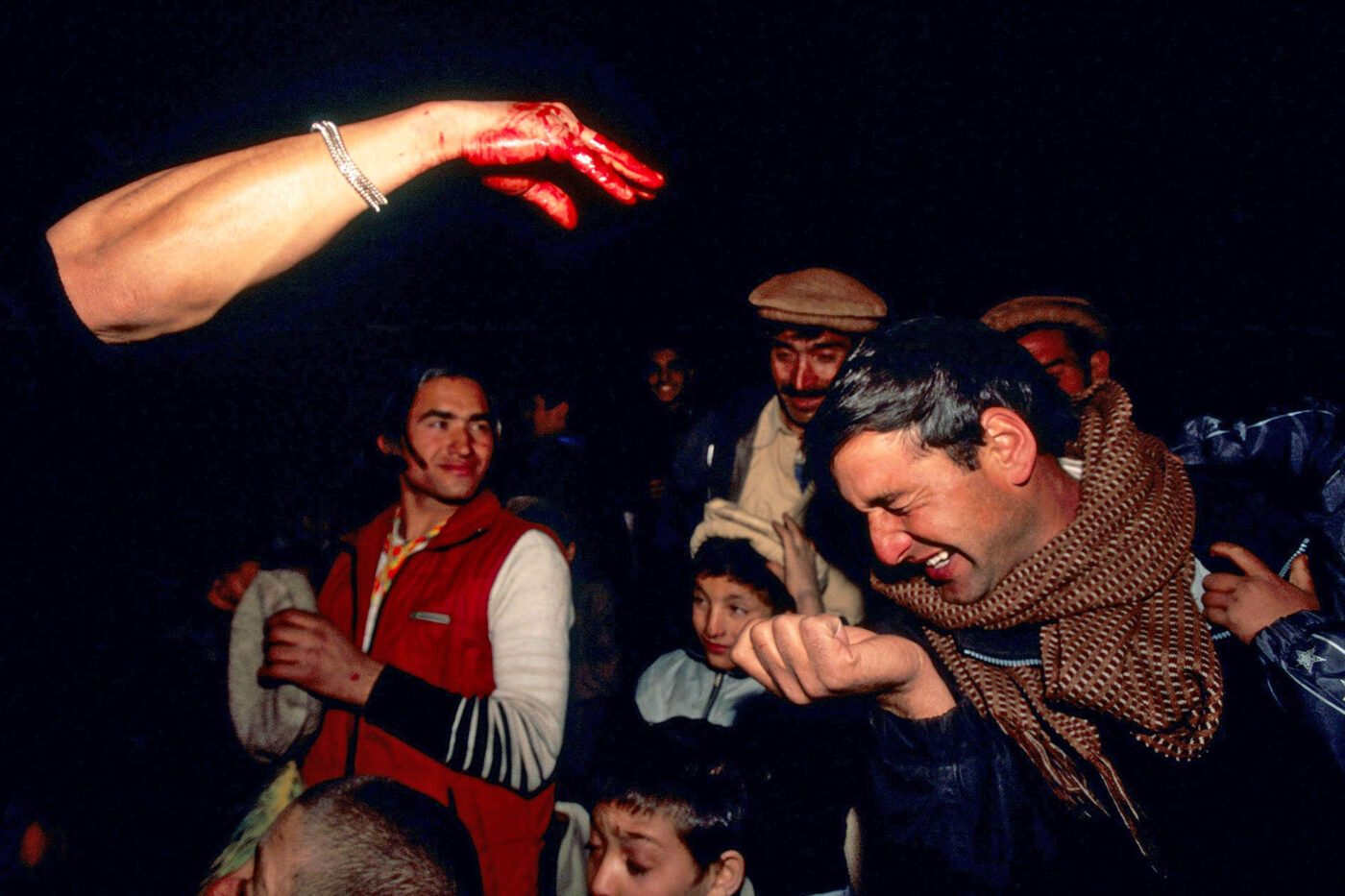 Several men participate in a Kalash celebration where men get purified by goat's blood.