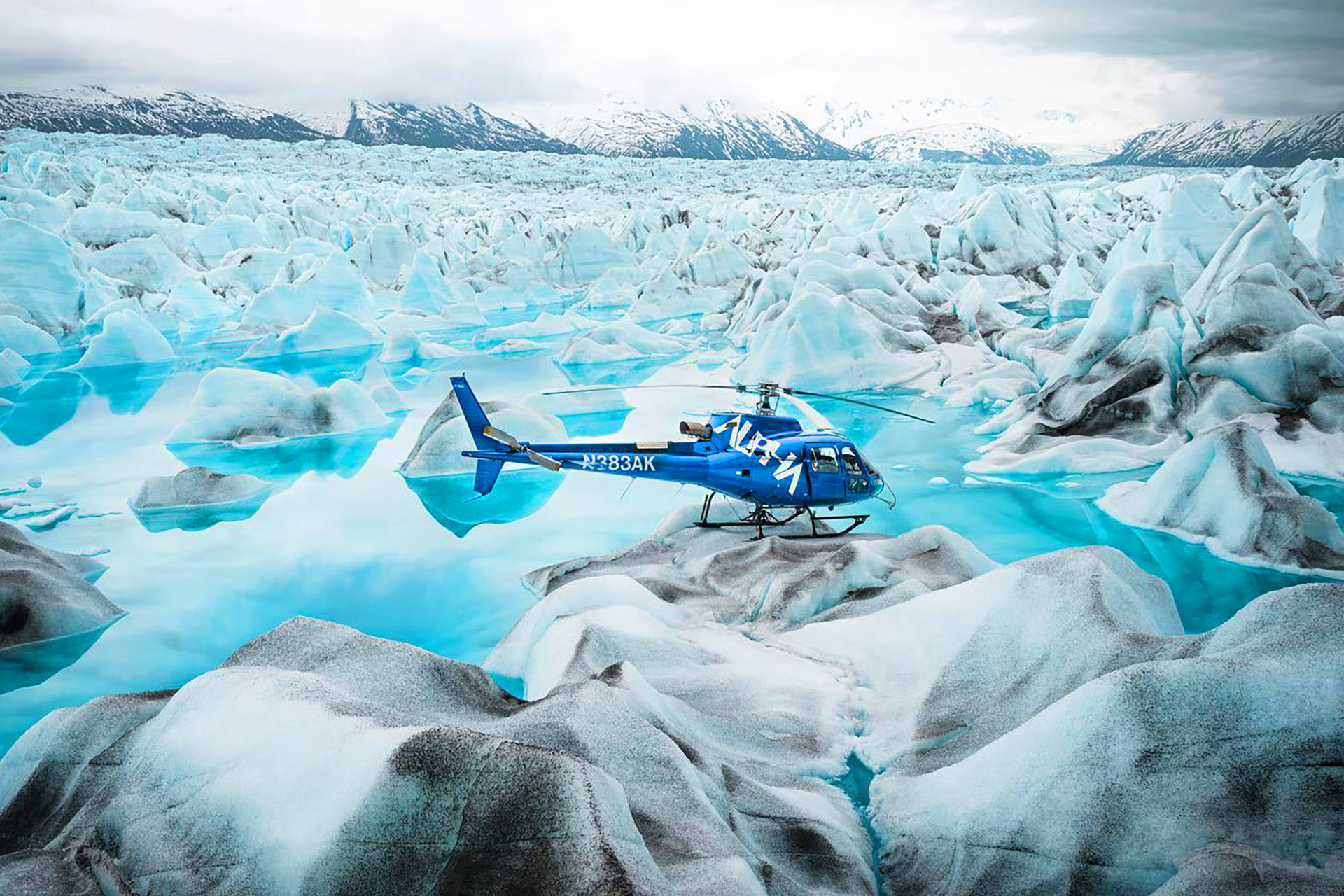 A helicopter has landed on the top of a glacier in Alaska, USA.