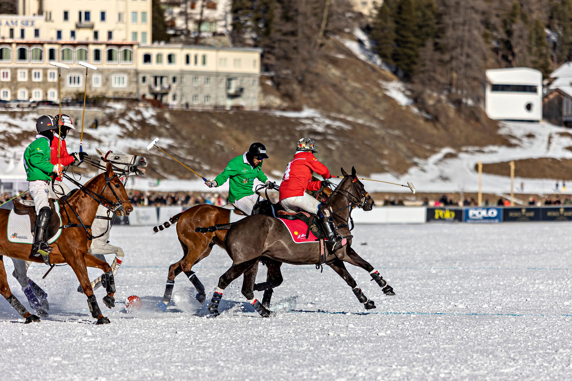A group of men playing a game of polo in the snow in St. Moritz, Switzerland.