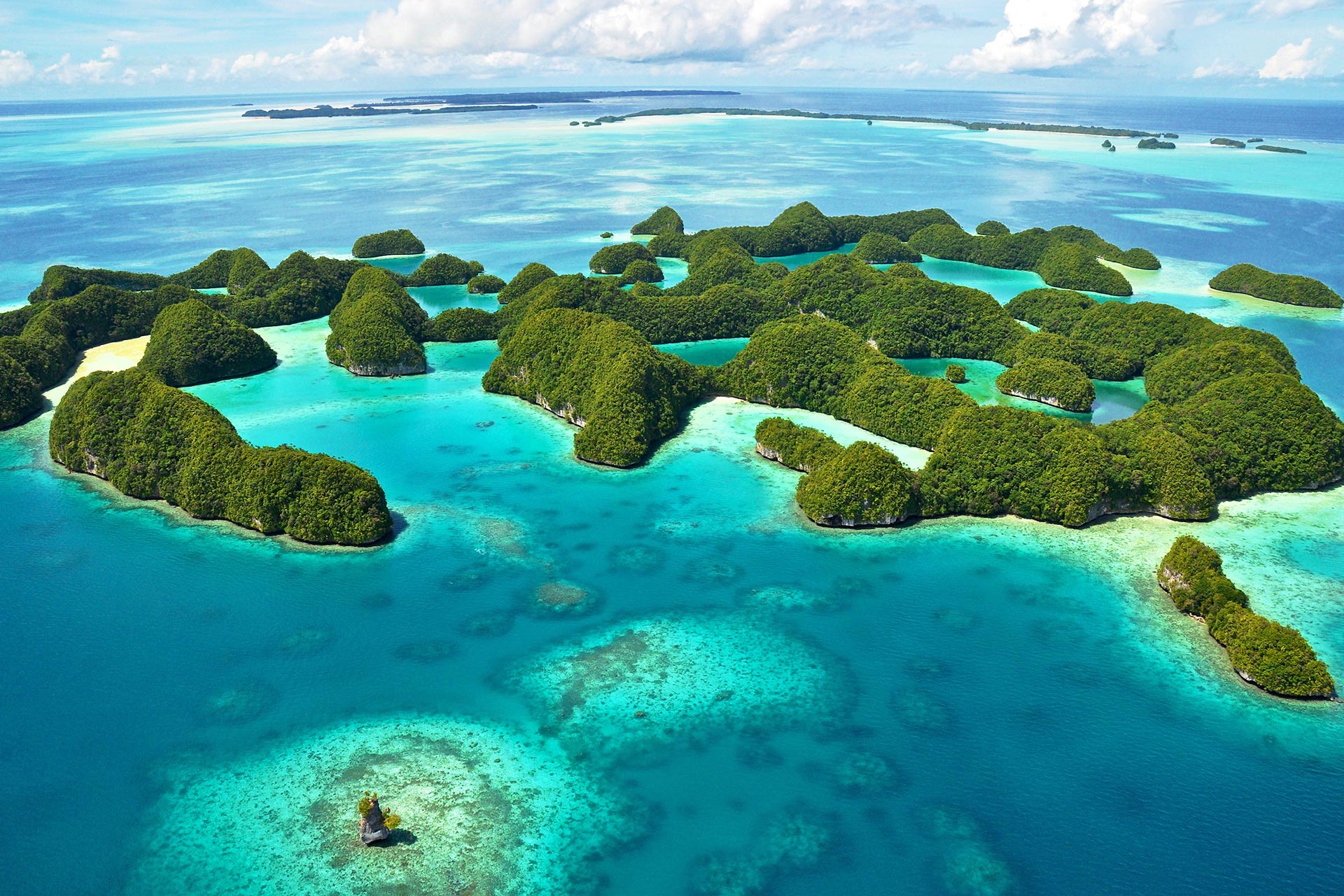 Foliage-covered islands protrude from turquoise-coloured water.