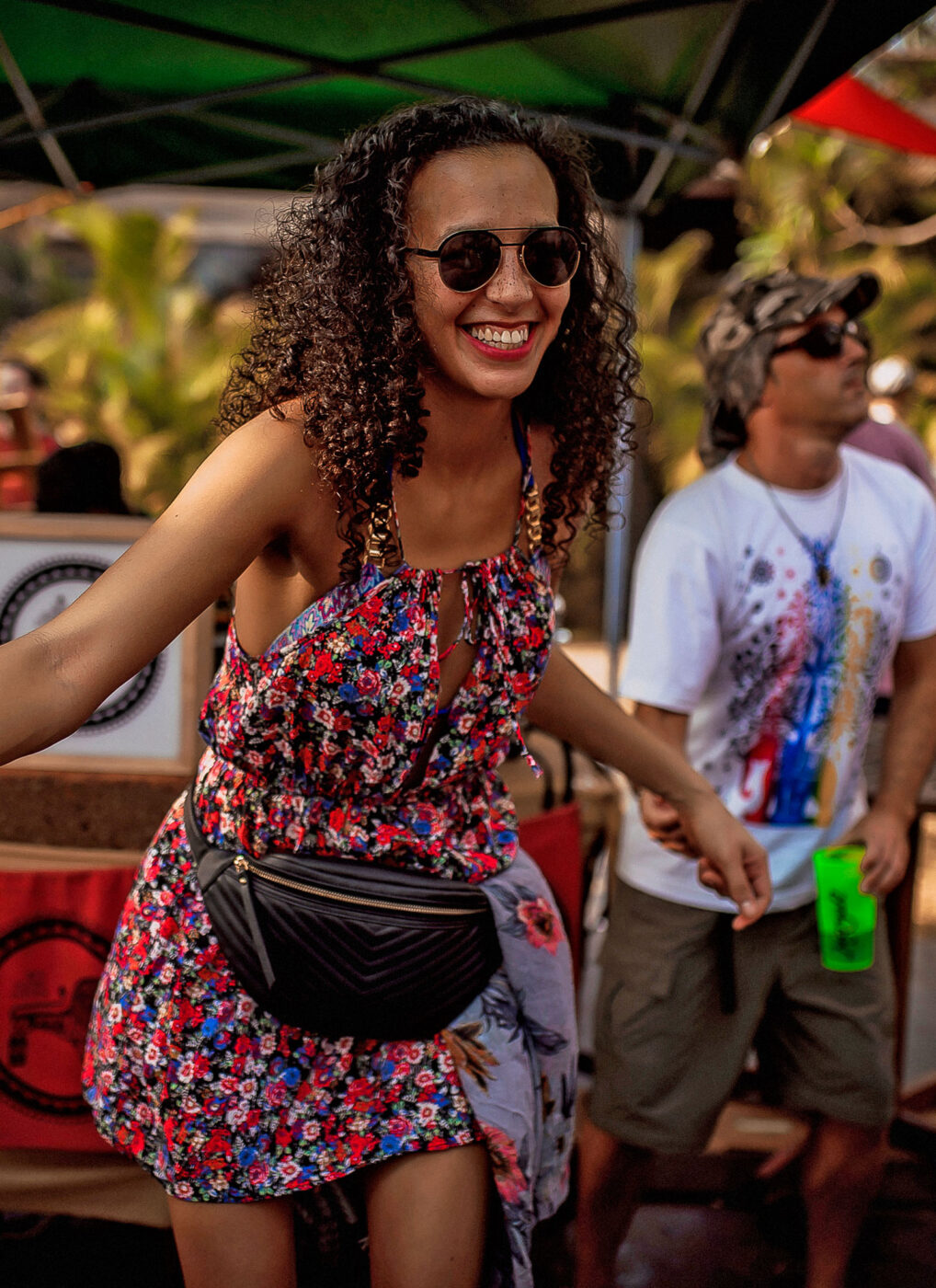 Smiling festivalgoer enjoying the vibrant atmosphere at the Goa Sunsplash reggae festival.