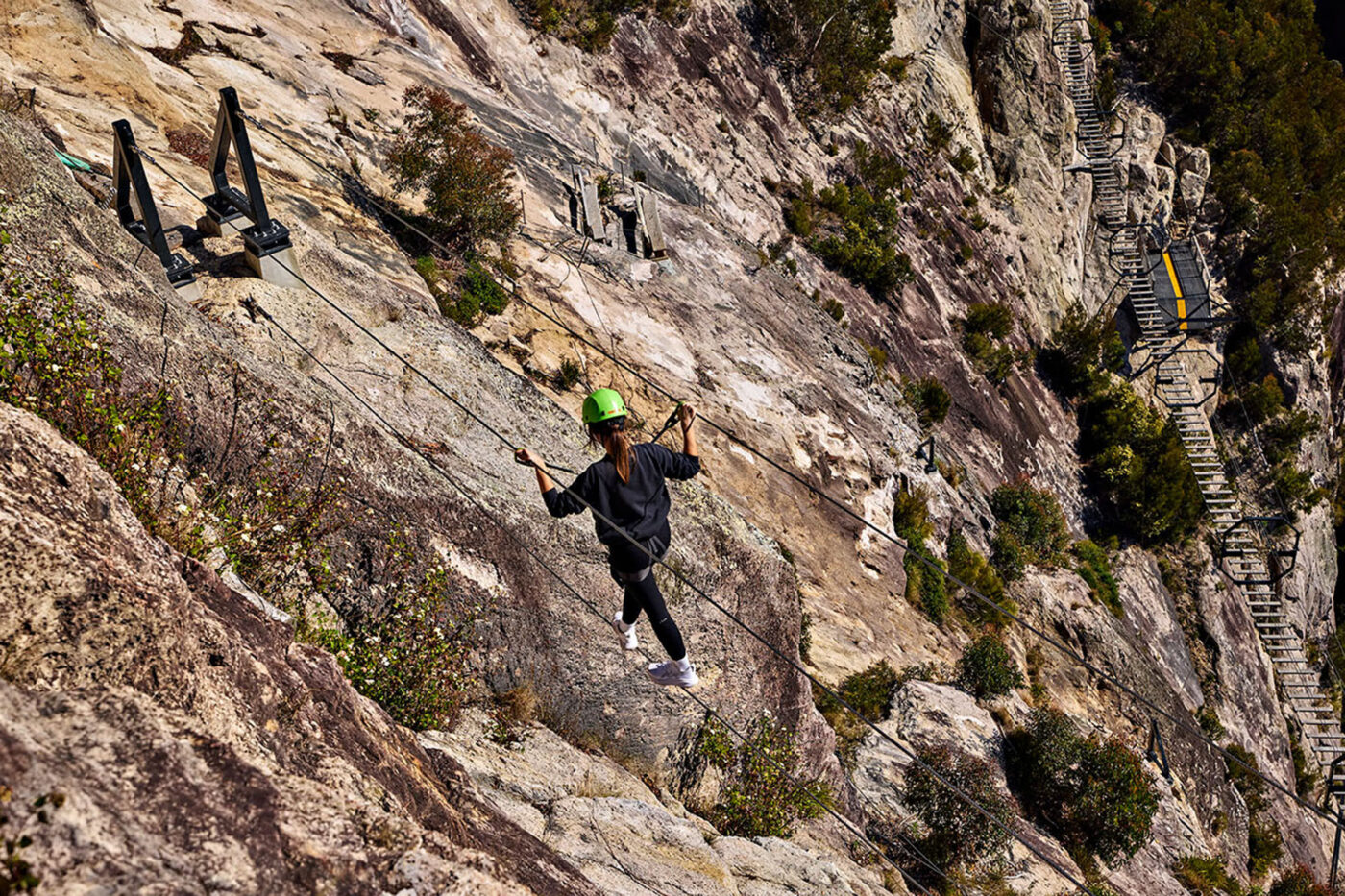 A woman on the via ferrata at Happitat Adventure Park in Lamington National Park.
