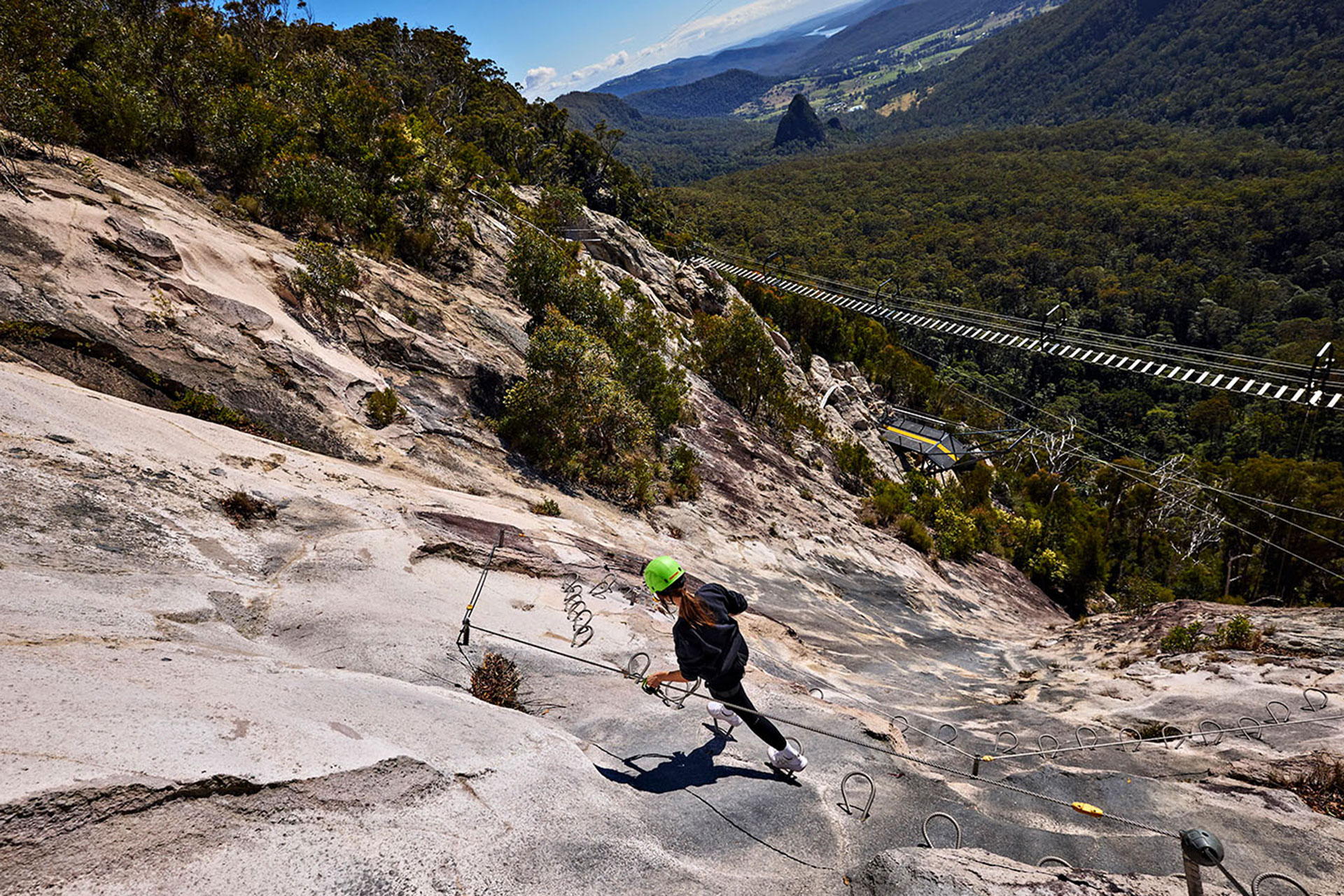 A woman on the via ferrata at Happitat Adventure Park in Lamington National Park.