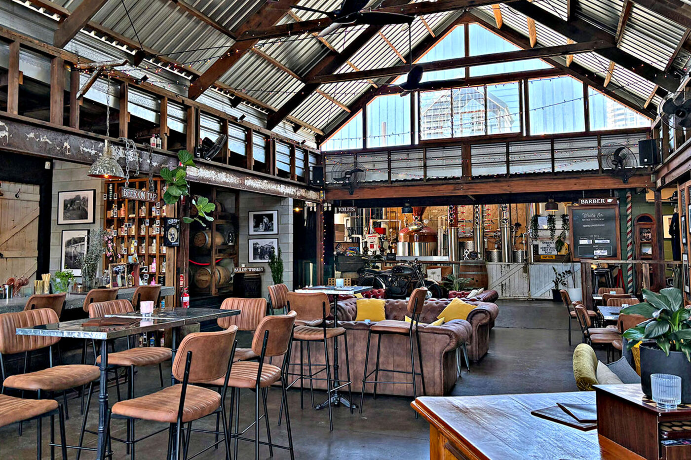 The wide, open space of Granddad Jack's Craft Distillery with the distillery visible in the back. 