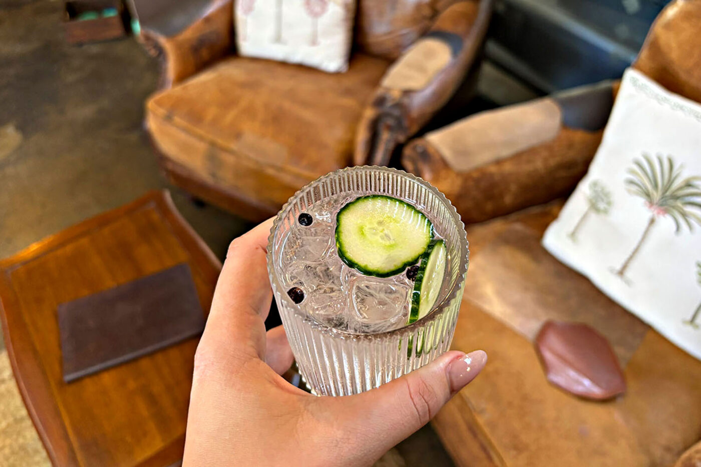 A glass filled with gin & tonic, some peppercorns and cucumber. Available at Granddad Jack's Craft Distillery. 