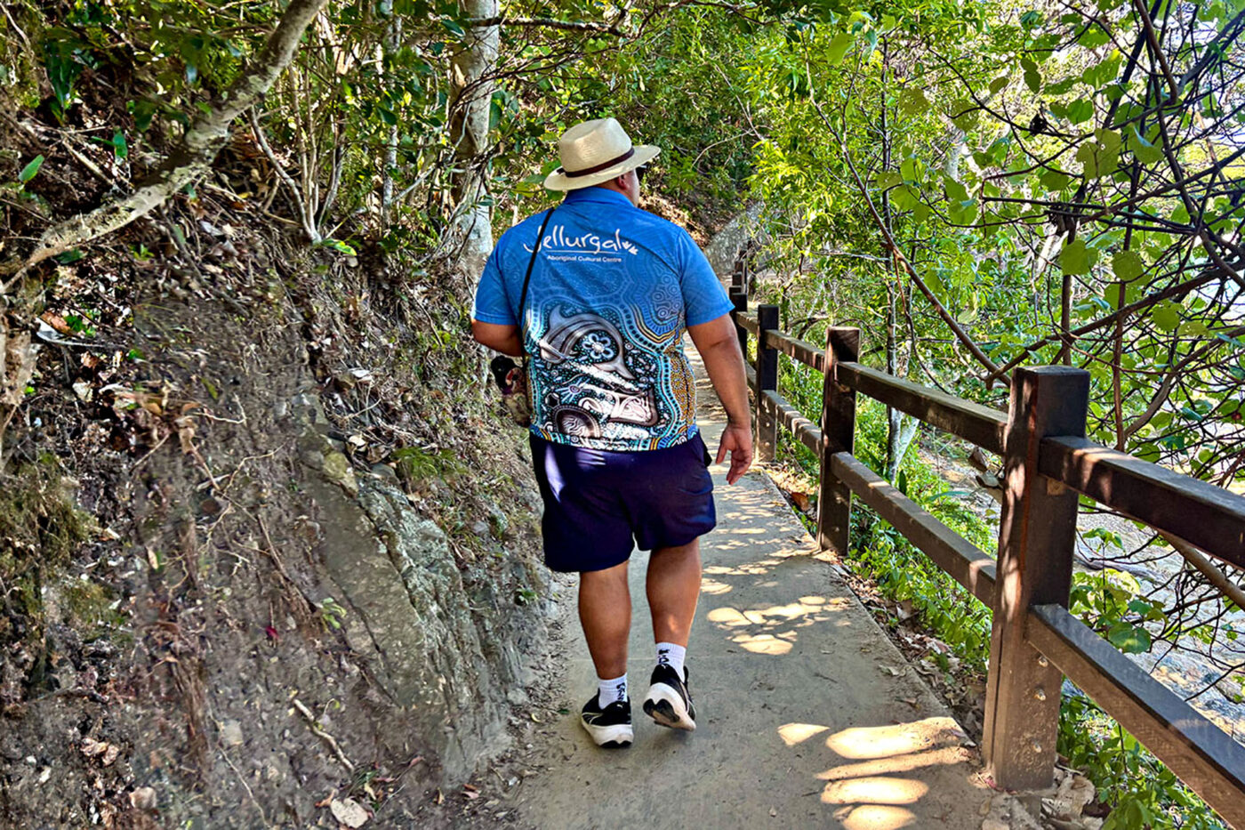 A representative of the Jellurgal Aboriginal Cultural Centre walks along a trail at Burleigh Headland. 