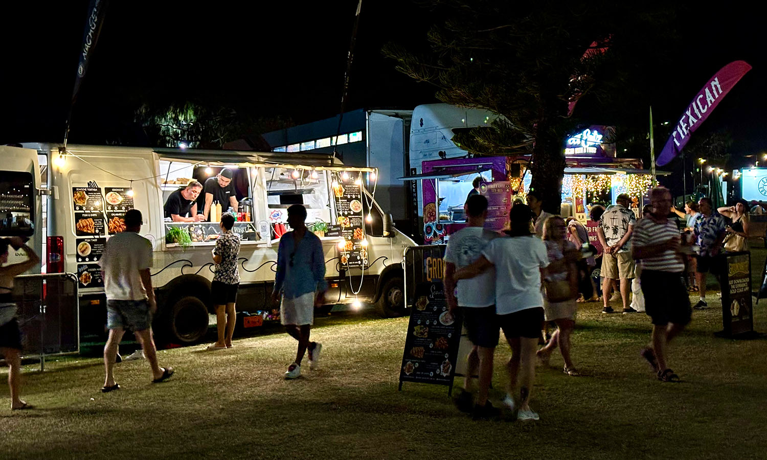 Food trucks serving various cuisine to festival goers.