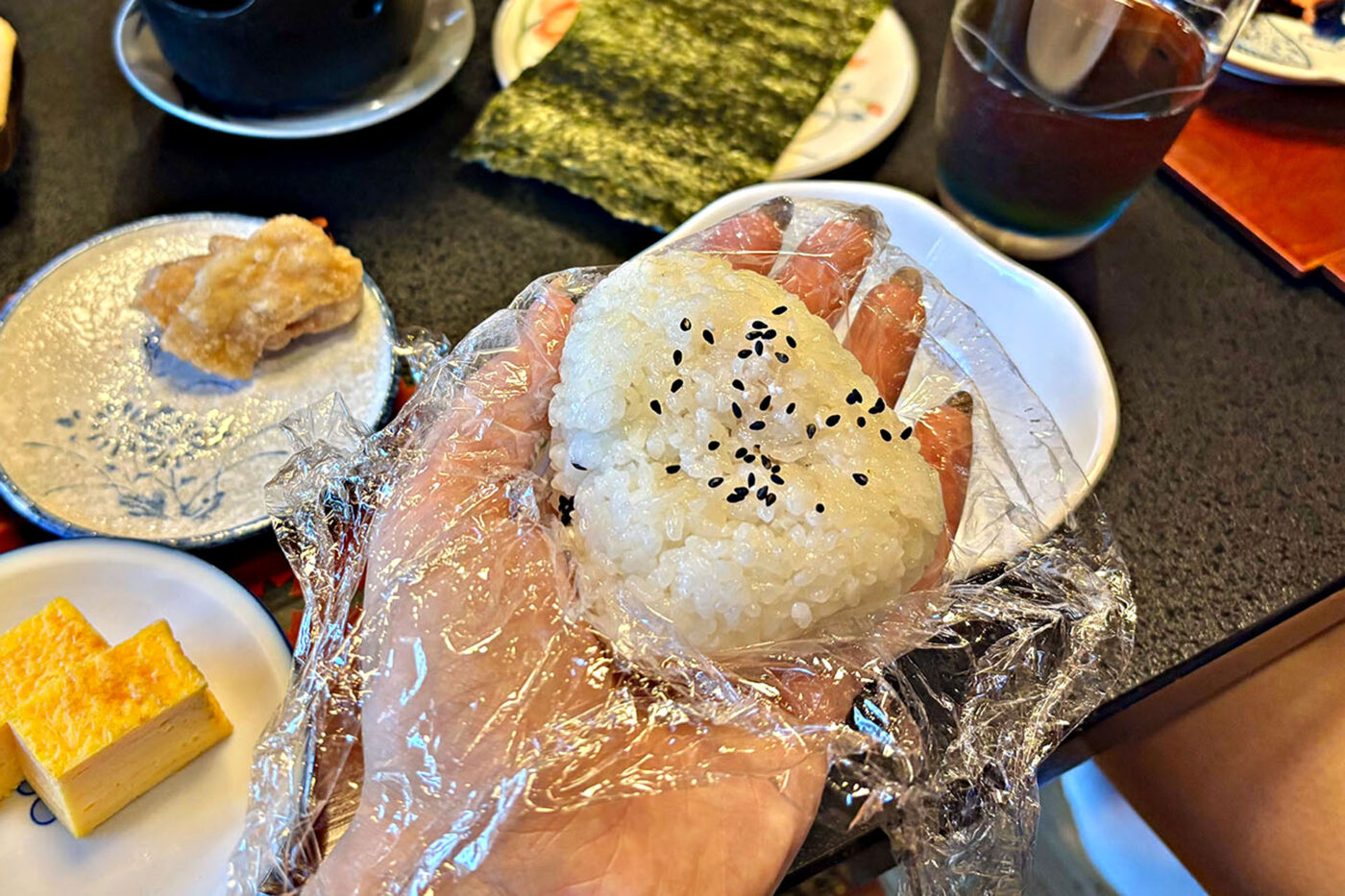 Moulding an onigiri triangle with sticky steamed rice.