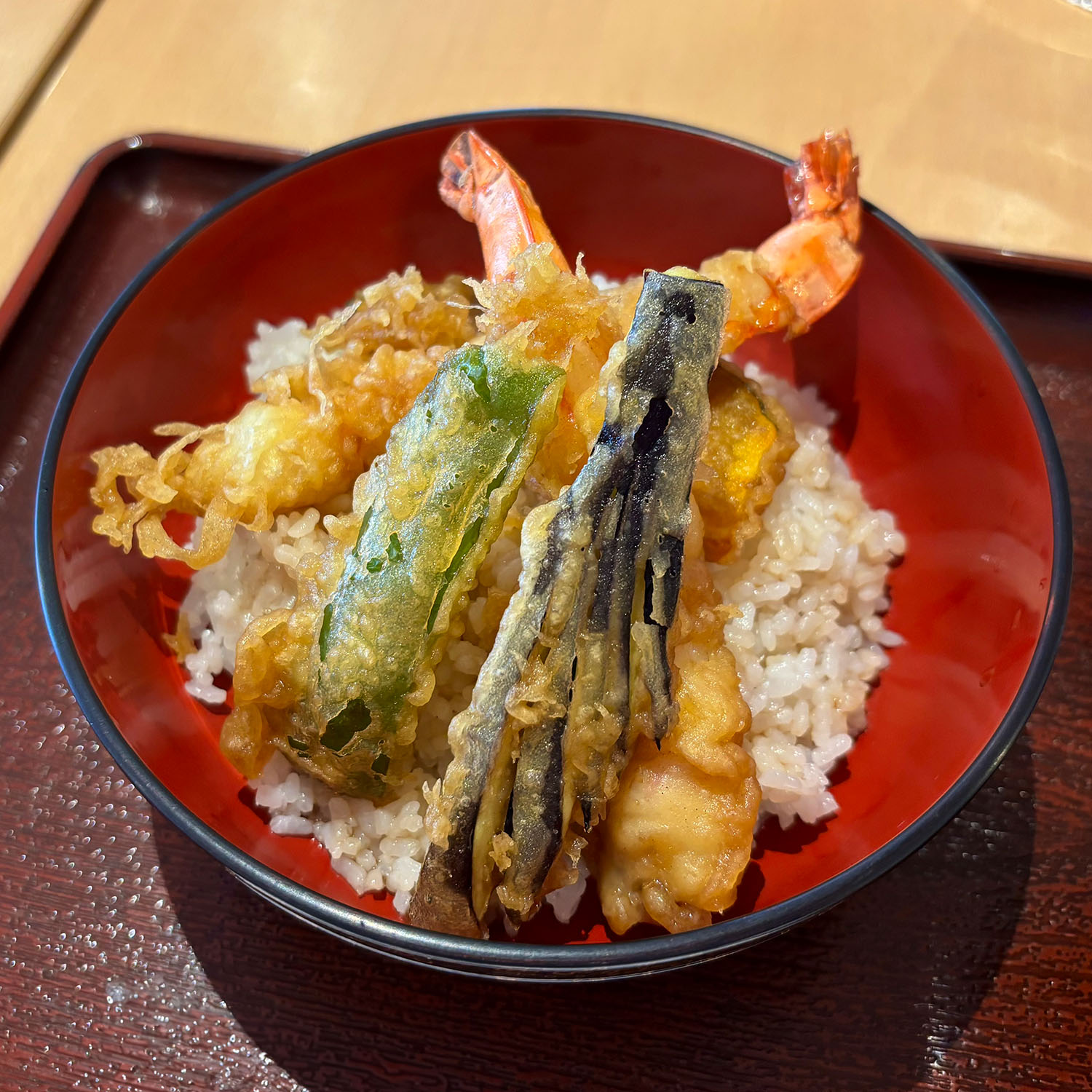 Crispy vegetable and prawn tempura on a bed of rice. 