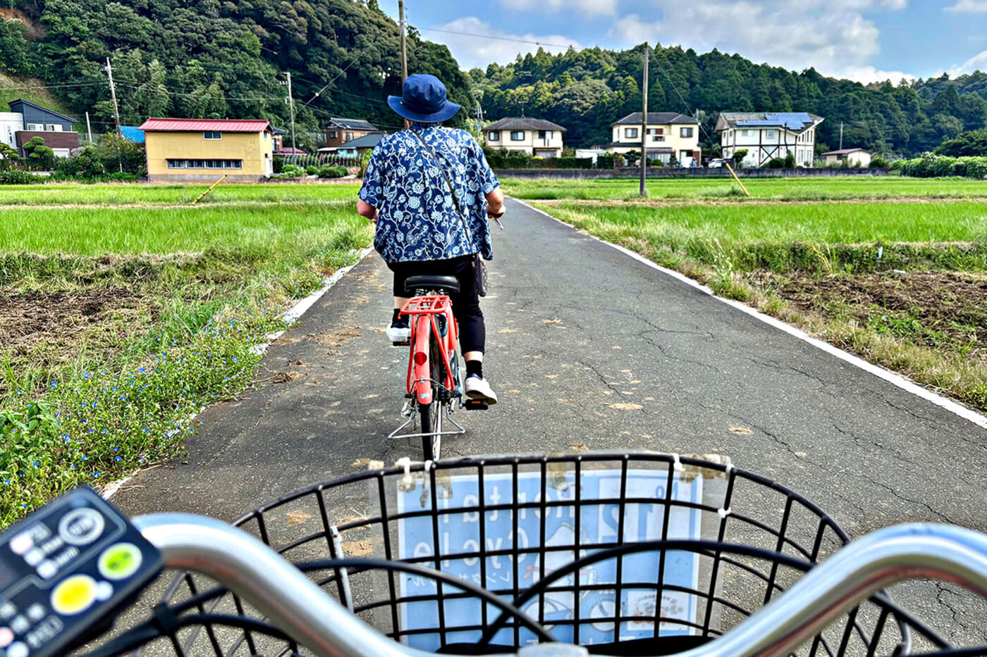 Two cyclists take to the rice field surrounded roads of outer Narita in Japan.