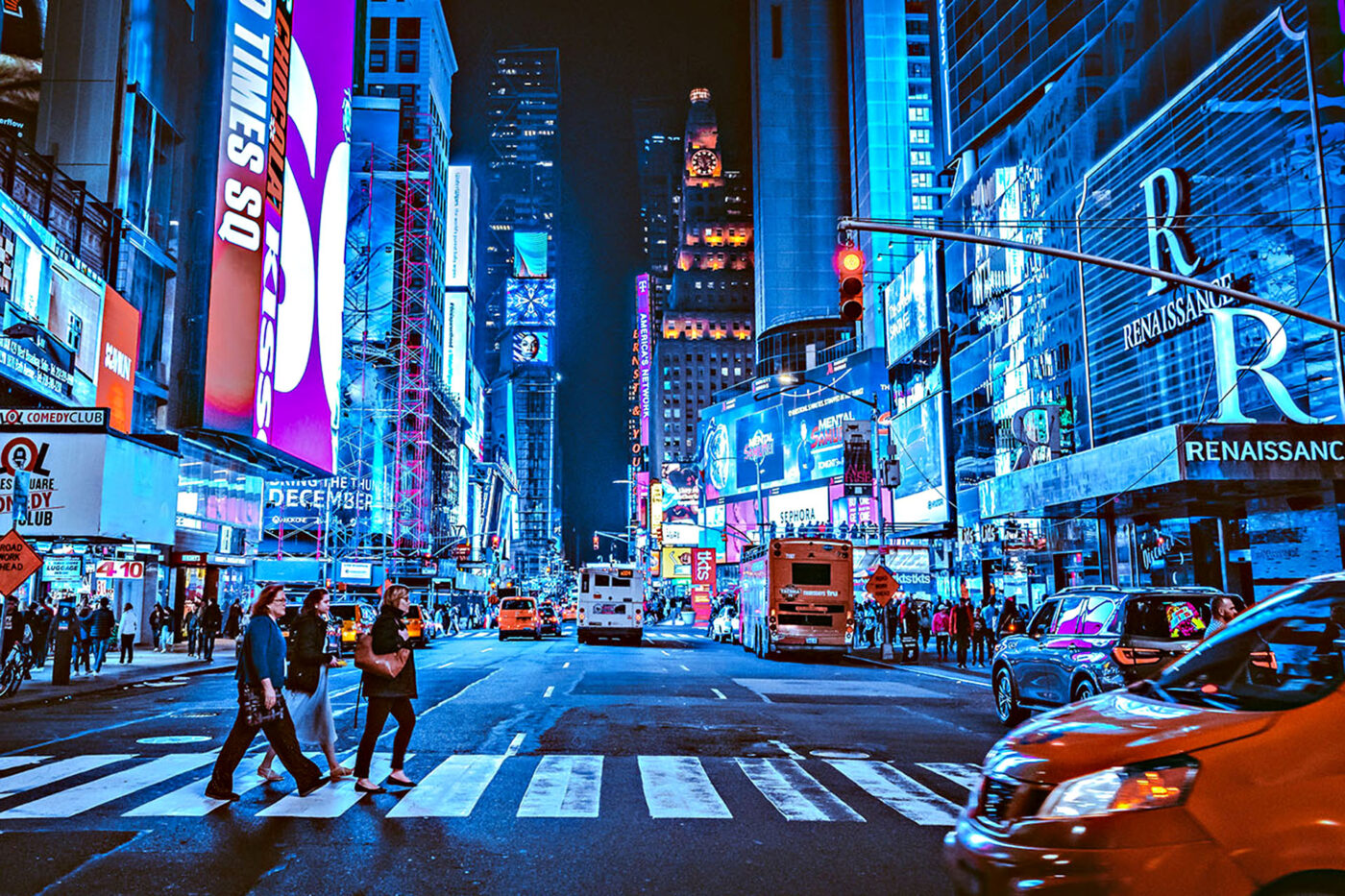 The bright lights of Times Square in NYC at nighttime.