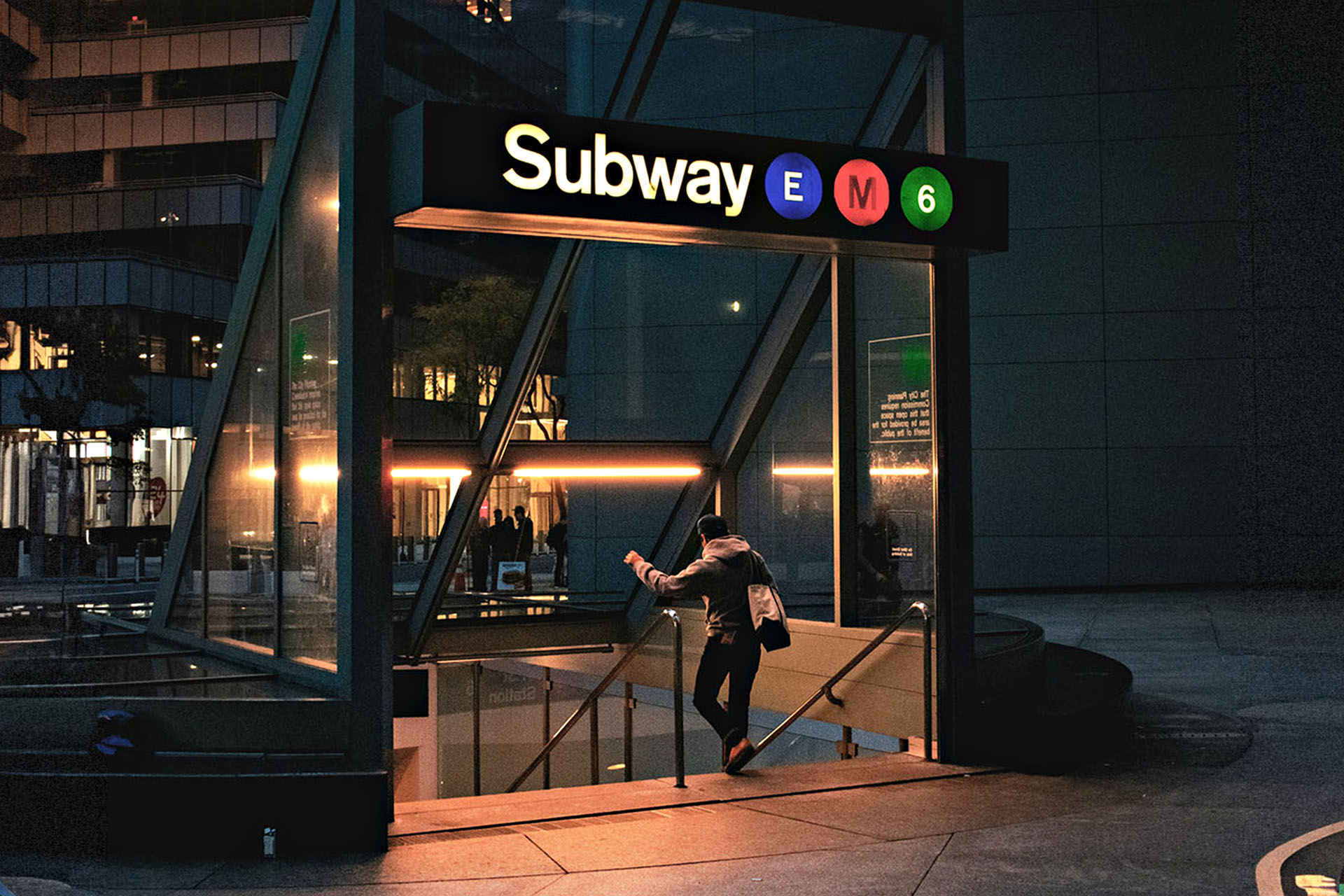 A man walks into the underground subway in NYC.