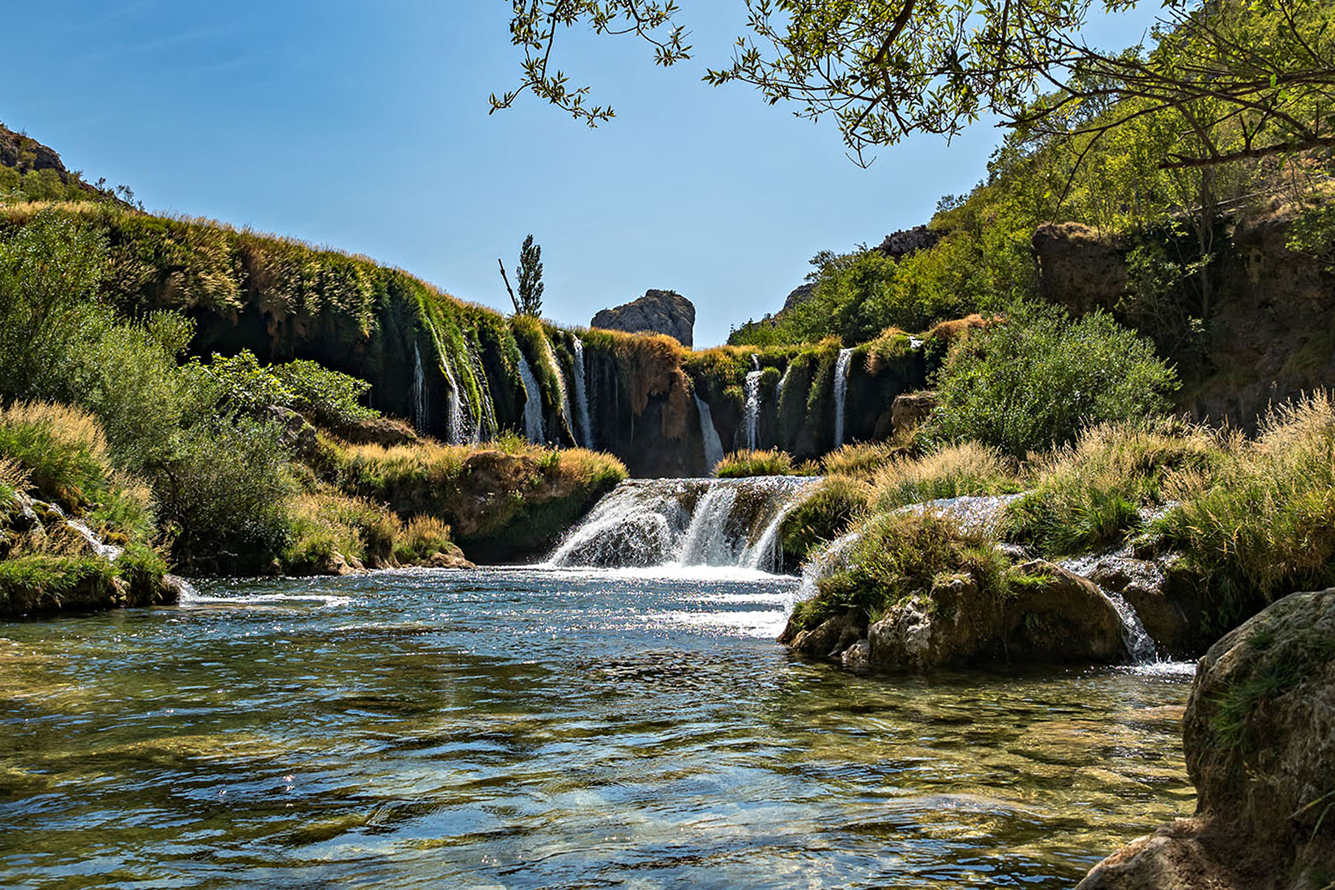 Waterfall surrounded by rugged Croatian canyon landscapes.
