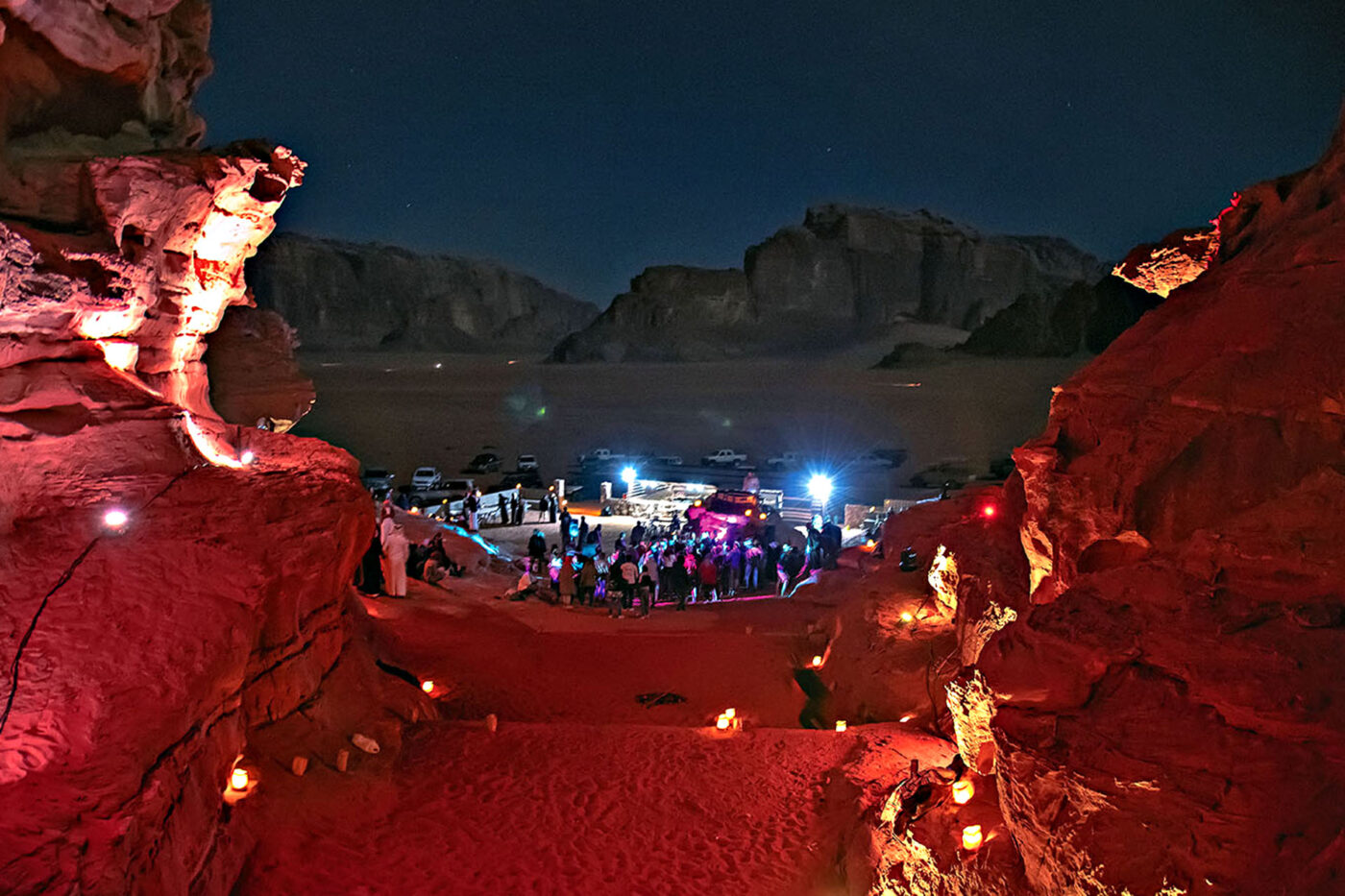 SA7RA-OUI electronic music festival illuminated among the red rock formations of Wadi Rum.