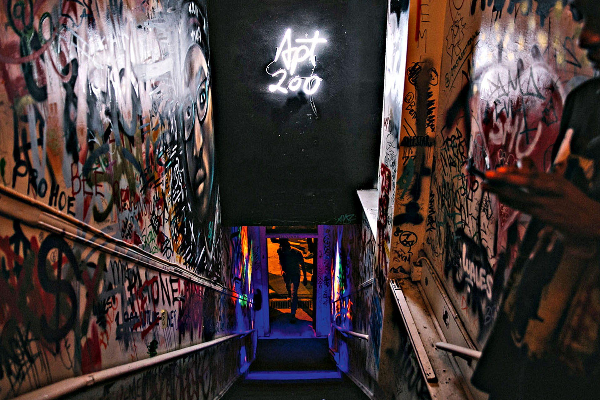 A graffiti-clad staircase doubles as the entrance to Apt. 200.