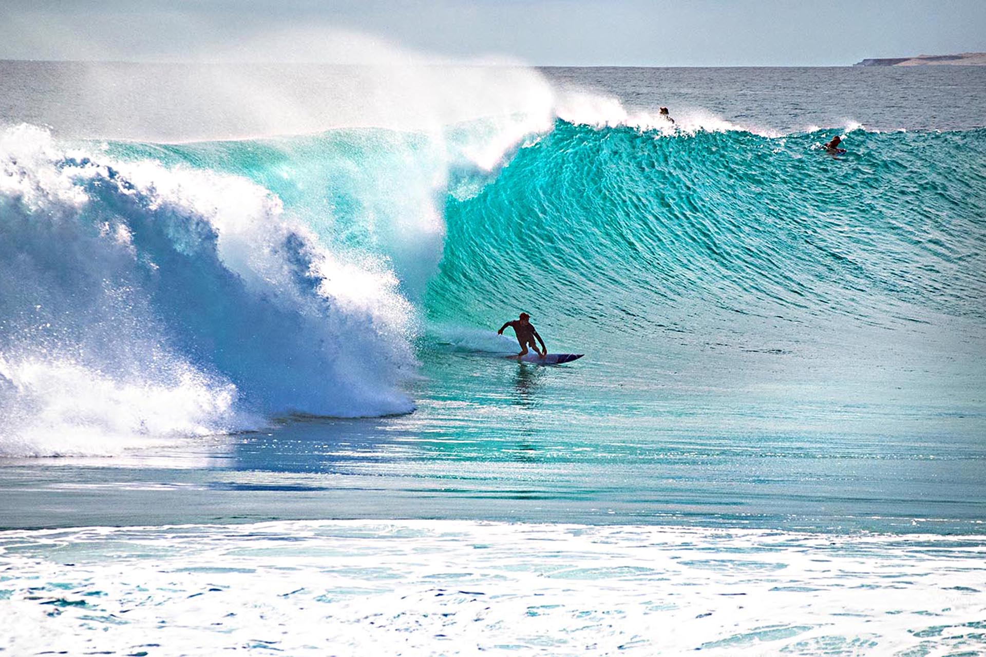 Surfer riding a large wave at Red Bluff, Quobba Station.