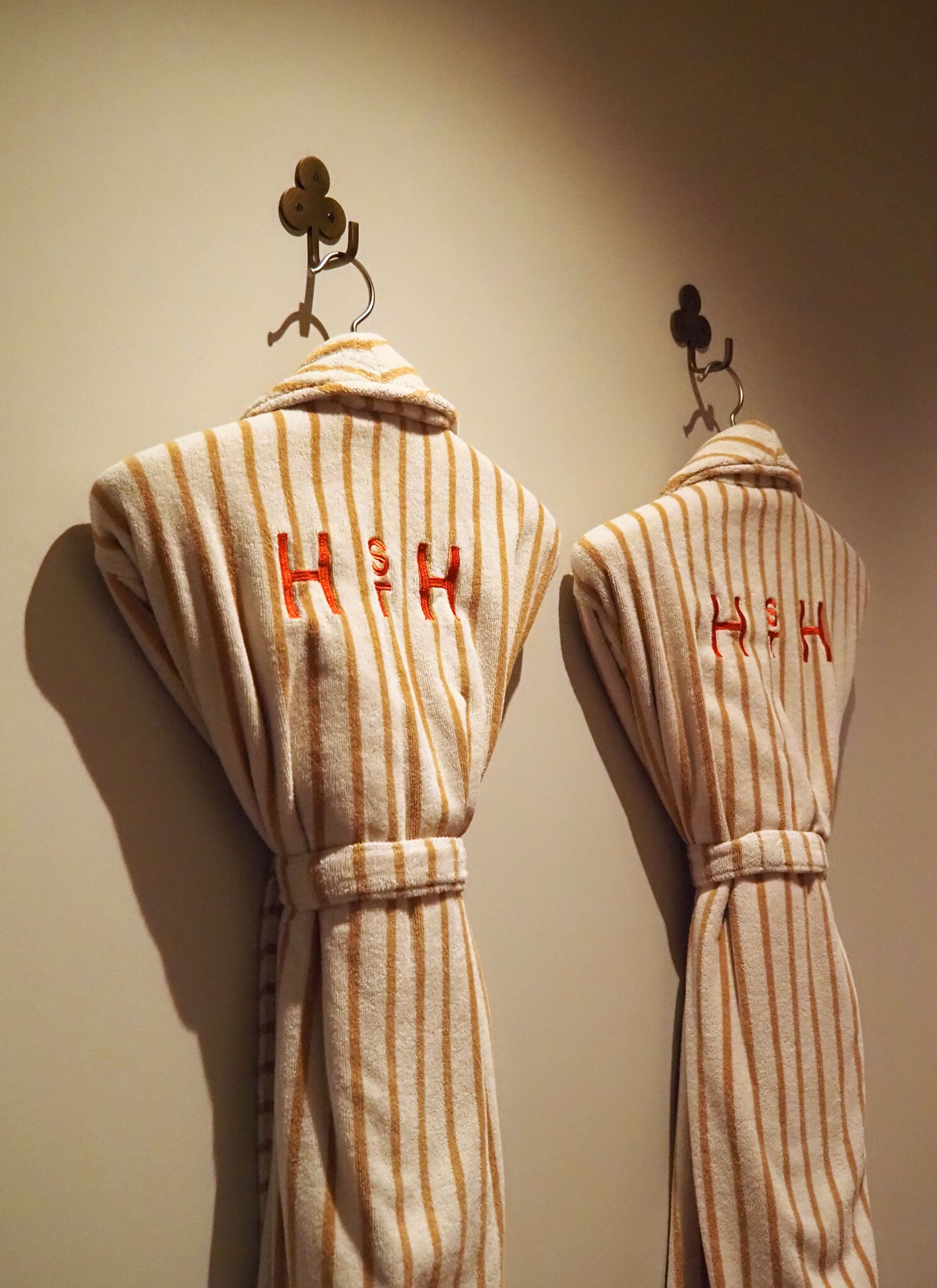 Striped Hannah St Hotel robes hanging inside a guest room at the boutique Melbourne hotel.