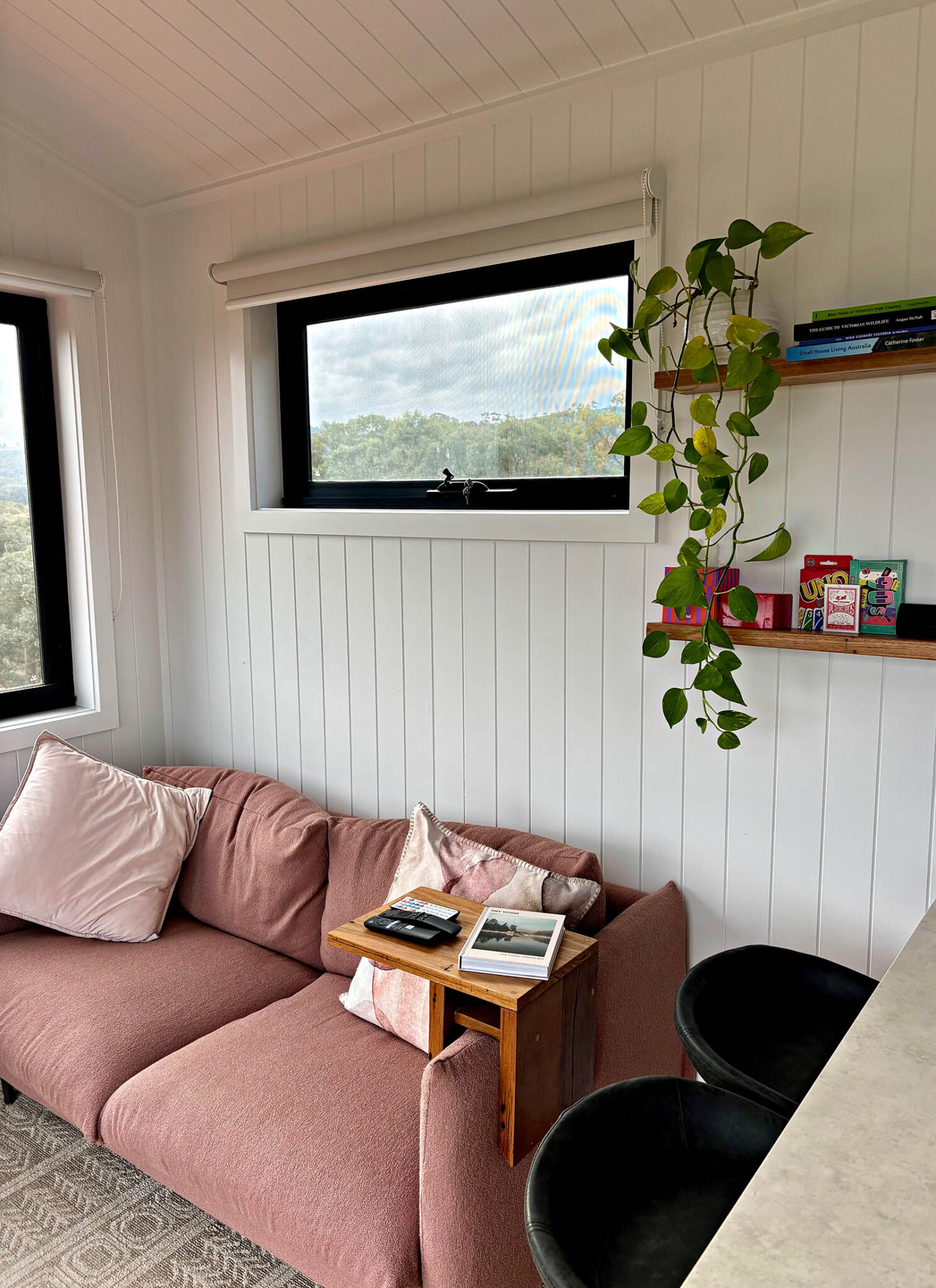 Cosy living area inside Karak Eco Lodge with large picture windows overlooking the Victorian countryside.