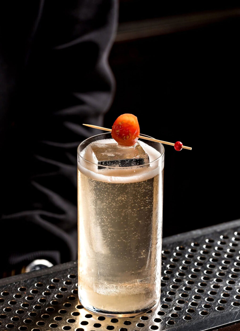Sparkling highball cocktail garnished with a skewered cherry tomato at Line Athens.