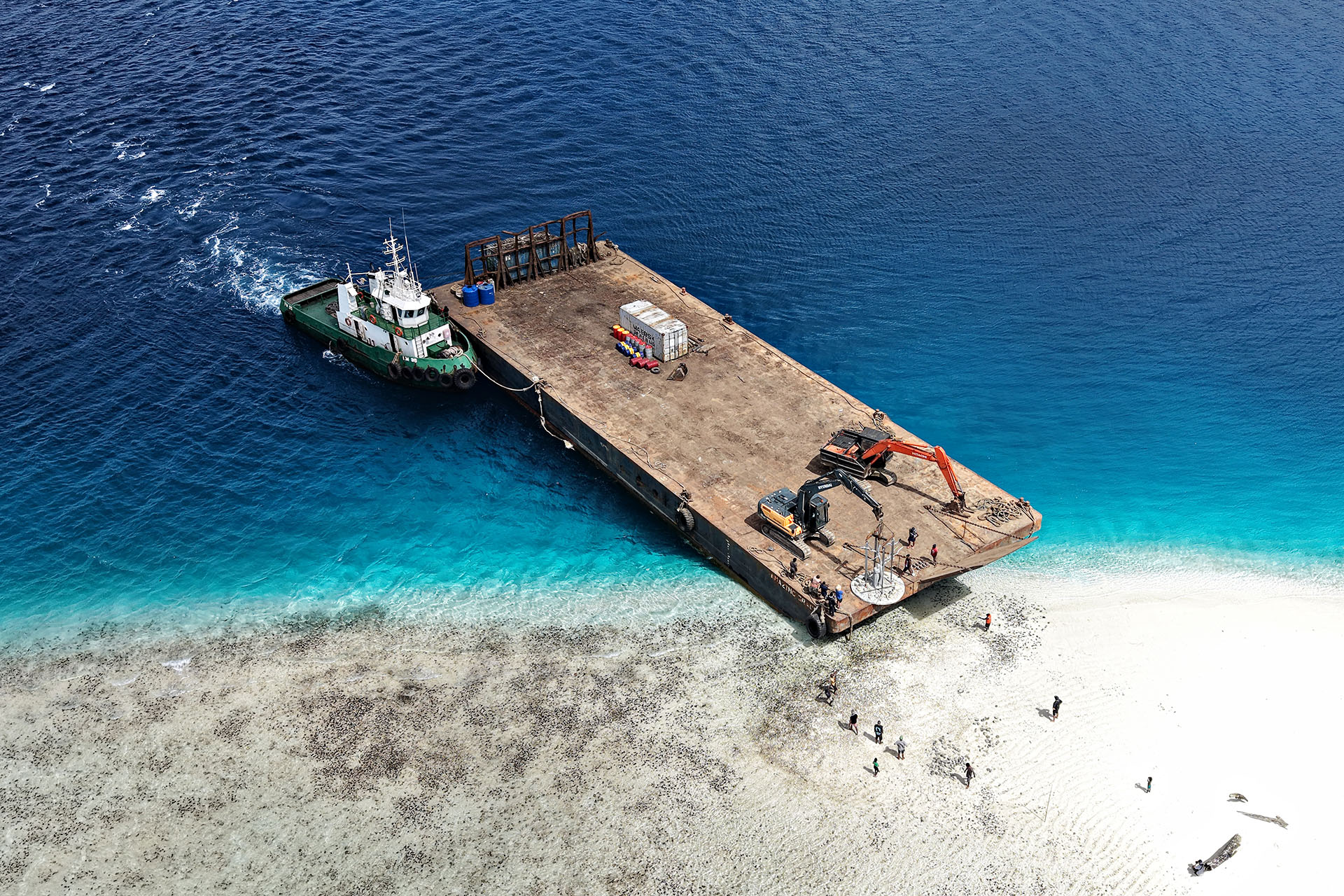 Barge delivering the Solomon Siren sculpture to a remote reef in the Solomon Islands.