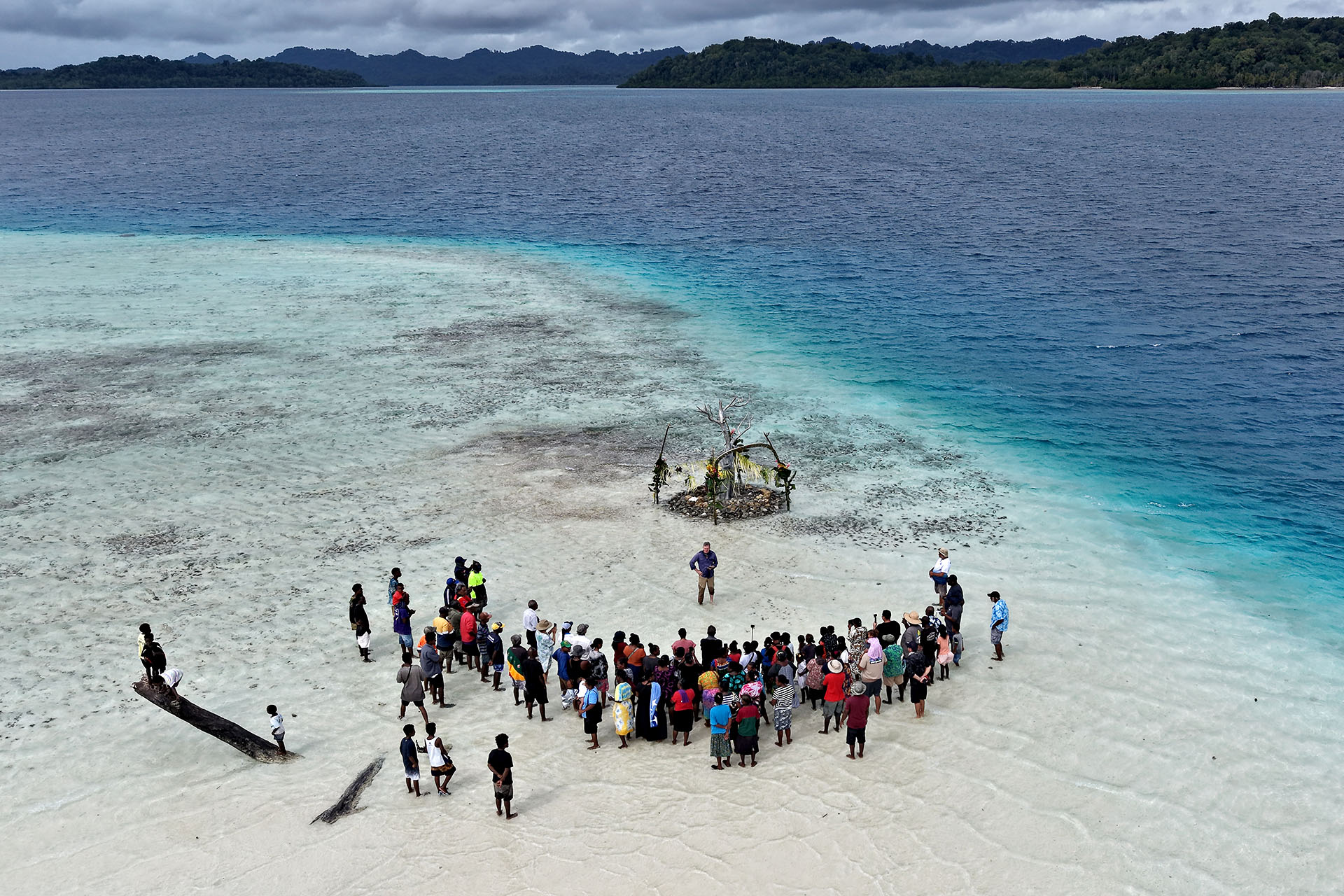 Community members gathered around the Solomon Siren sculpture during its unveiling on a reef in the Solomon Islands.