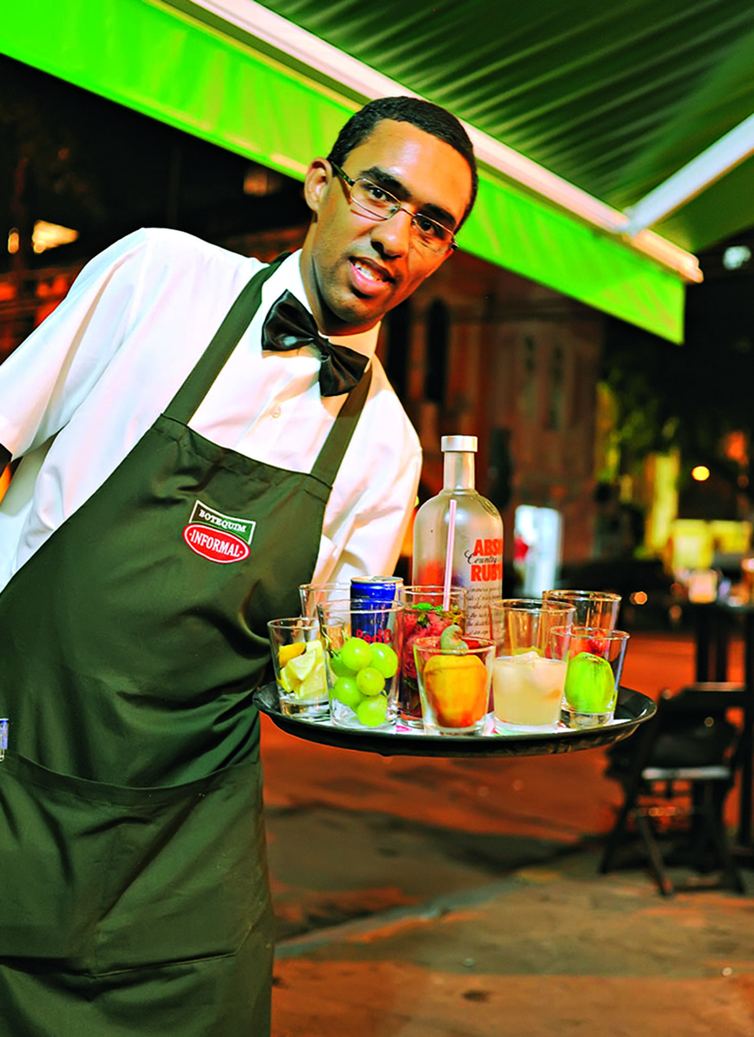 A waiter offers a selection of potent fruit cocktails at a boteco in Humaitá.