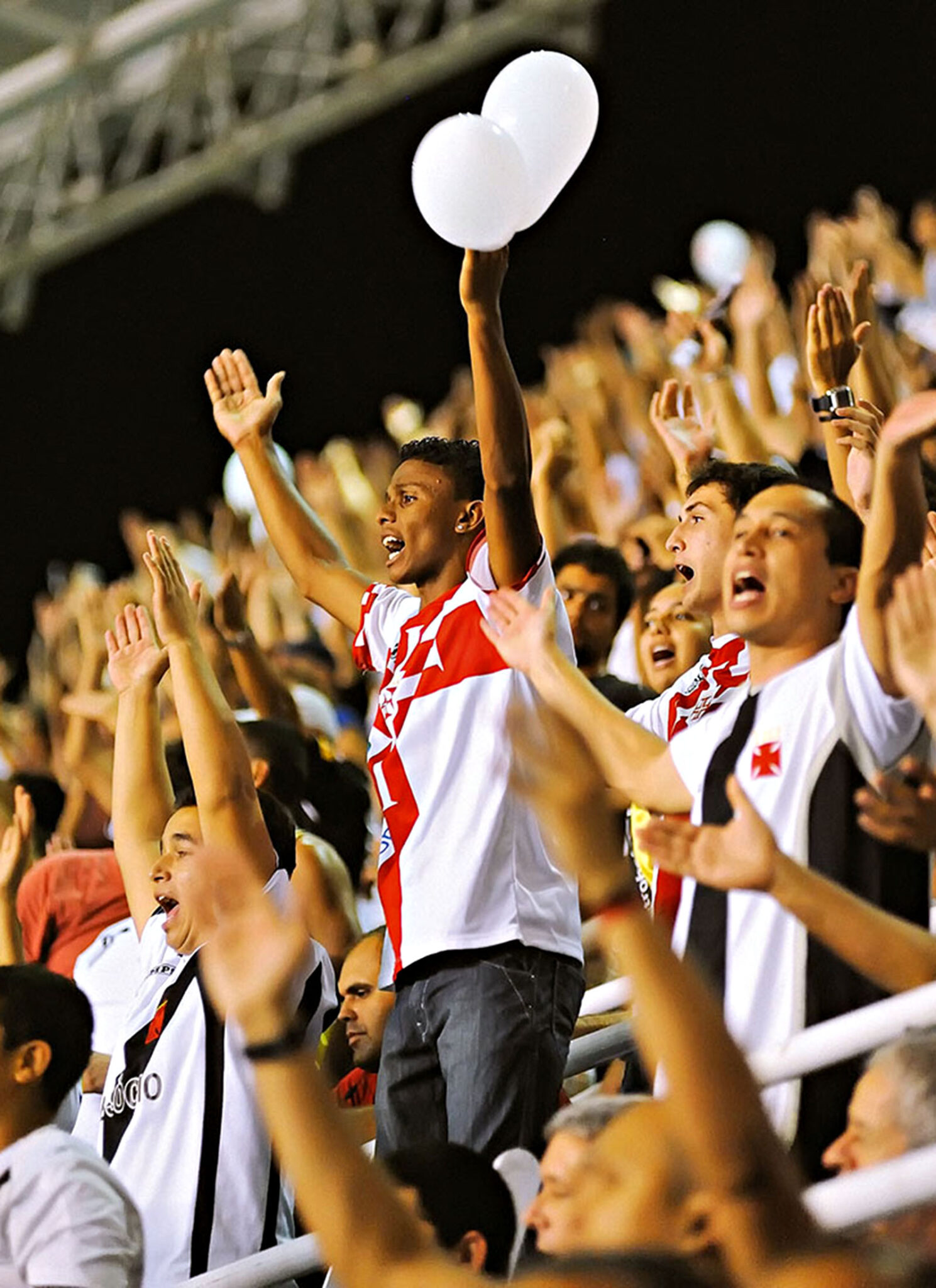 Passionate fans at a futebol clássico between teams Botafogo and Vasco de Gama at São Cristóvão stadium.